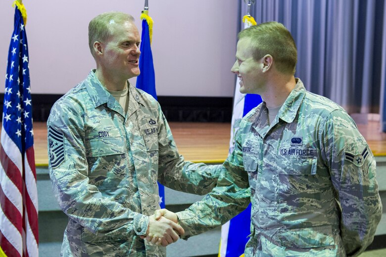 Chief Master Sgt. of the Air Force James Cody personally thanks Airman 1st Class Jonathan North, Air Force Technical Application Center after an Airman’s Call March 24, 2014, at Patrick Air Force Base, Fla. Cody stressed the importance of upcoming changes but said the real emphasis of his visit was to thank each and every member. (U.S. Air Force photo/Matthew Jurgens)
