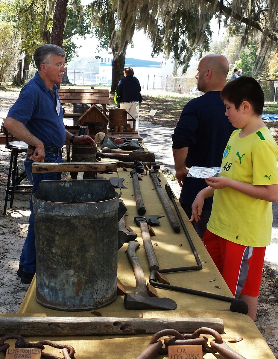 Raymon Melvin, a local turpentine industry expert, explains the history of the turpentine industry at Eglin Air Force Base, Fla., to attendees during the 3rd Annual Eglin Archaeology Day held at Jackson Guard March 22. Melvin's display was one of several activities and booths available at the event hosted by Eglin Cultural Resources to celebrate Florida's Archaeology Month. More than 120 people participated in Archaeology Day to learn more about Eglin's heritage, cultural resources and the importance of stewardship. (Courtesy photo)
