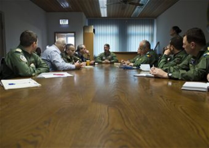 U.S. Air Force Lt. Col. Benjamin Busch, 52nd Operations Support Squadron commander, briefs members of the Romanian air force during a familiarization tour at Spangdahlem Air Base, Germany, March 26, 2014. During the visit, U.S. Airmen provided a familiarization tour of F-16 Fighting Falcon fighter aircraft operations, maintenance and support. (U.S. Air Force photo by Staff Sgt. Chad Warren/Released)