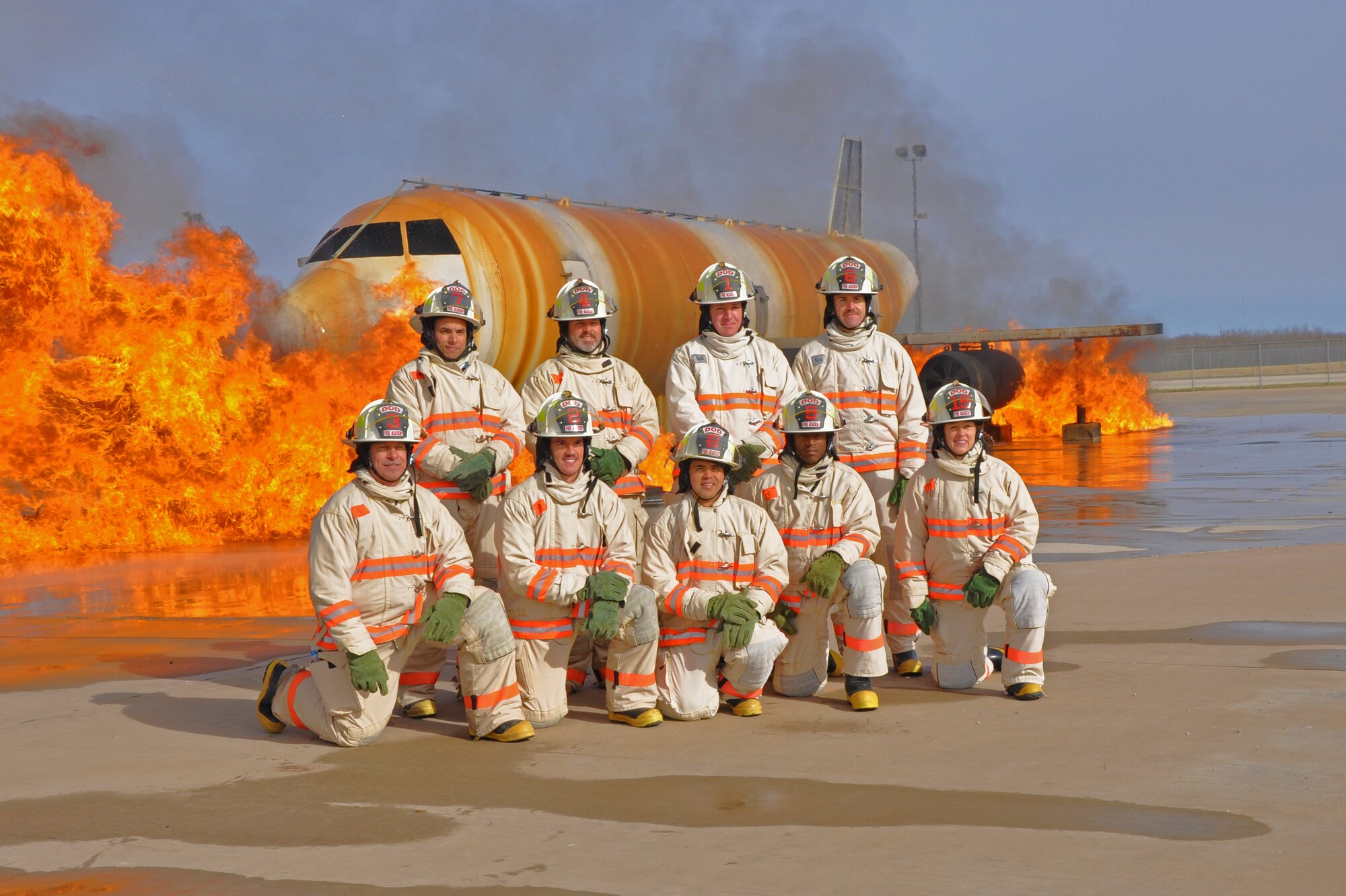 GOODFELLOW AIR FORCE BASE, Texas –  Students from the Fire Marshal Course pose for a class picture in front of the large frame aircraft trainer at the Louis F. Garland DOD Fire Academy March 19. The academy services all firefighting aspects of the DOD; including Army, Marine Corps, Navy, Air Force and Civil Service employees as well as fire protection specialists from foreign countries. (U.S. Air Force photo/ Airman 1st Class Breonna Veal)