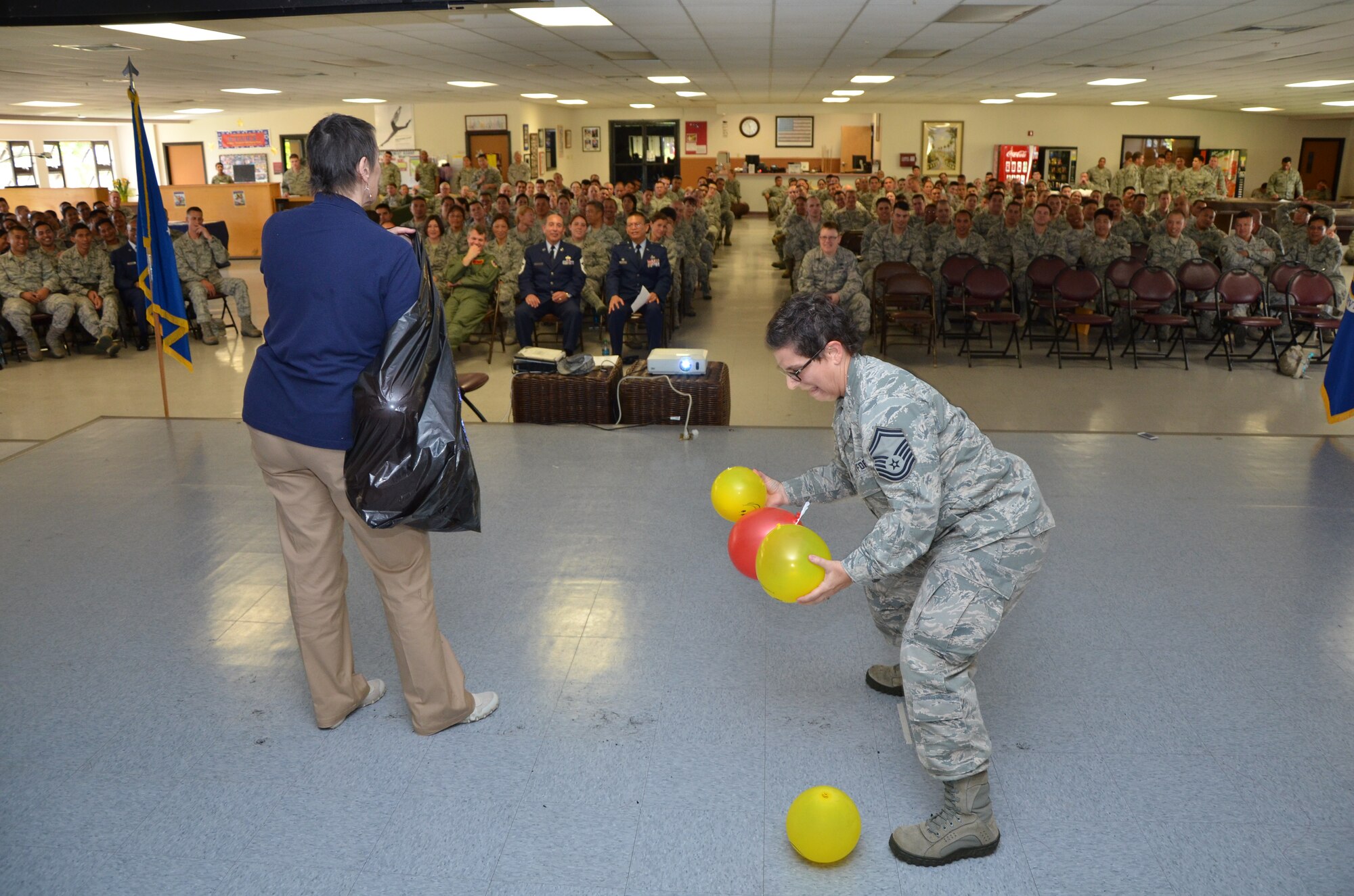 Senior Master Sgt. Patricia Kawa’a, right, superintendent of Force Health Management with the 624th Aeromedical Staging Squadron, tries to juggle balloons that Karen Orcutt, left, a case facilitator for the Air Force Reserve Command's Psychological Health Advocacy Program (PHAP), tosses at her to demonstrate the many challenges a reservist faces in managing civilian life with military duties, Joint Base Pearl Harbor-Hickam, Hawaii, Mar. 9, 2014. PHAP offers support and solution-focused resources in order to improve outcomes and positively influence total health and well-being for the Air Force Reserve member and their families. (U.S. Air Force photo by Tech. Sgt. Phyllis Keith)