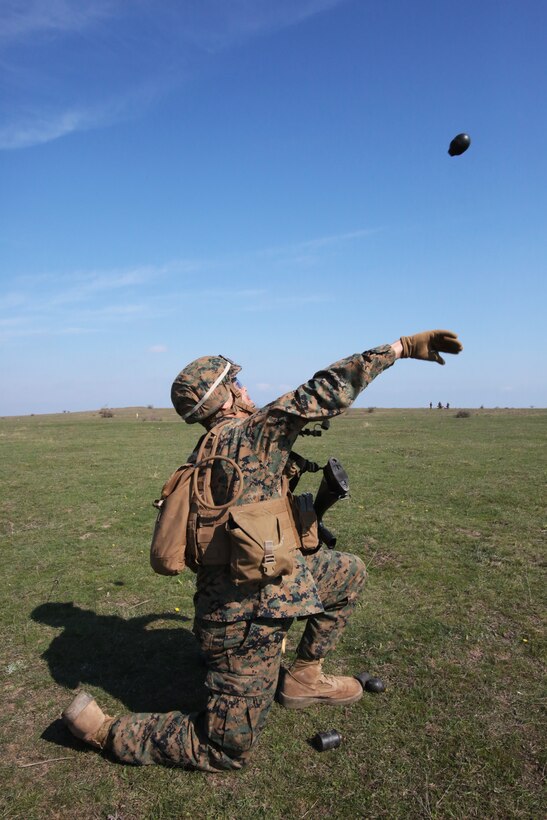 Lance Corporal Saldis Salcedo, mortarman, Weapons Company, 3rd Battalion, 8th Marines, assigned to Black Sea Rotational Force 14 throws a training grenade,  during a combined maneuver live fire exercise at Babadag Training Area, Romania, 26 March, 2014.  Romanian service members and Marines from BSRF-14 integrated fire teams during the live fire exercise.  Black Sea Rotational Force 14 is a task force of Marines and sailors with the mission to sustain positive relationships with partner nations uphold regional stability and increase military operational capabilities while also proving the ability for rapid crisis response in the Black Sea, Balkan and Caucasus regions of Eastern Europe. (Official Marine Corps photo by Staff Sgt. Tanner M. Iskra, BSRF Combat Camera/Released)