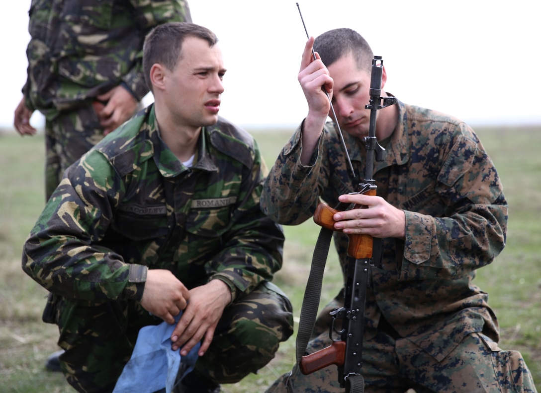 Lance Cpl. Patrick Phelan, a mortarman with Weapons Company, 3rd Battalion, 8th Marine Regiment, 2nd Marine Division assigned to Black Sea Rotational Force 14, learns how assemble and disassemble an AK-74 rifle with the help of a Romanian soldier with 307th Naval Infantry Bn. after jointly participating in a live-fire exercise aboard Babadag Training Area in Romania March 26, 2014. Black Sea Rotational Force 14 is a contingent of Marines and sailors tasked with maintaining positive relations with partner nations, regional stability and increasing interoperability while providing the capability for rapid crisis response, as directed by U.S. European Command, in the Black Sea, Balkan and Caucasus regions of Eastern Europe. (Official Marine Corps photo by Lance Cpl. Scott W. Whiting, BSRF PAO/ Released)