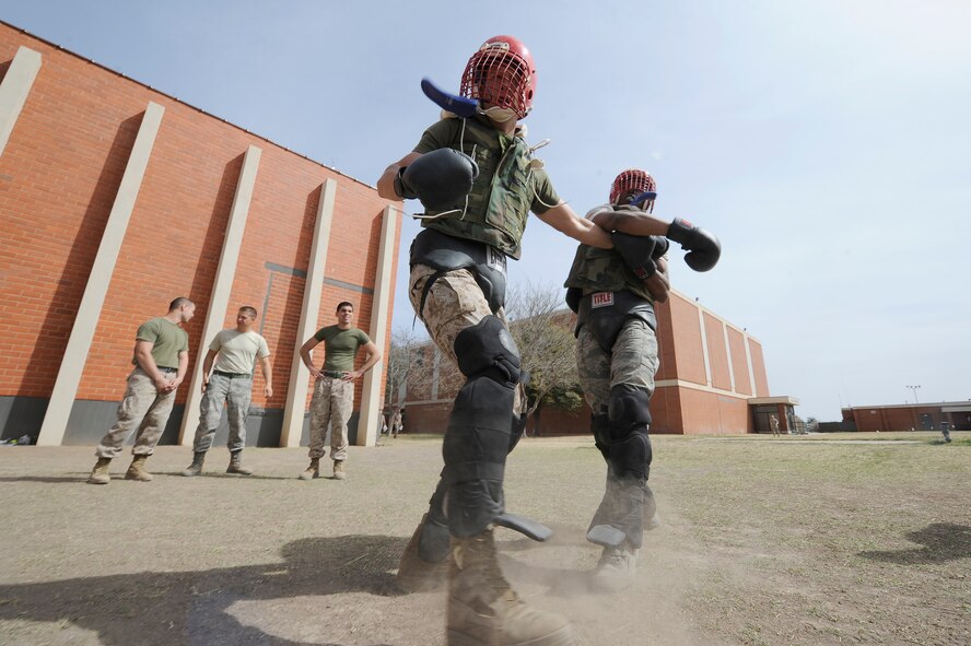 Joint service members train in the Marine Corps Martial Arts Program March 19, 2014, at Goodfellow Air Force Base, Texas. MCMAP is a close-quarters combat system that also stresses mental and character development. Entry-level MCMAP training is required of all Marines, but it can be utilized by all U.S. warfighters. (U.S. Air Force photo/Staff Sgt. Austin Knox)