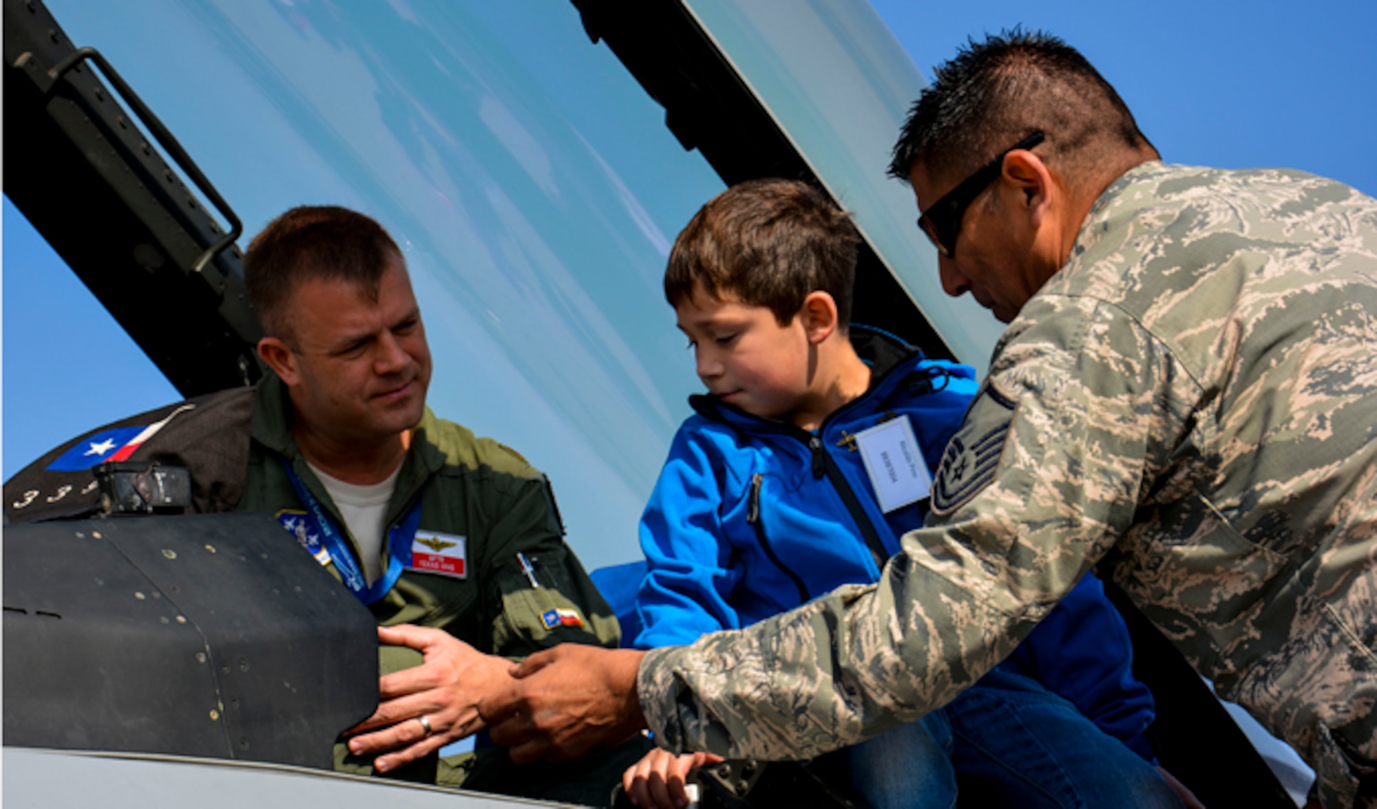 A Chilean boy from the Teletón Foundation gets an up-close view inside an F-16 Fighting Falcon and discusses the aircraft with Maj. Scott Elrod and Master Sgt. Carlos Rodriguez on March 26, 2014, at the FIDAE Air Show in Santiago, Chile. Nearly 60 Airmen are participate as subject matter experts during FIDAE, hosting static displays of the C-130 Hercules and F-16. Elrod is an F-16 pilot and Rodriquez is an F-16 maintenance specialist. (U.S. Air Force photo/Capt. Justin Brockhoff)