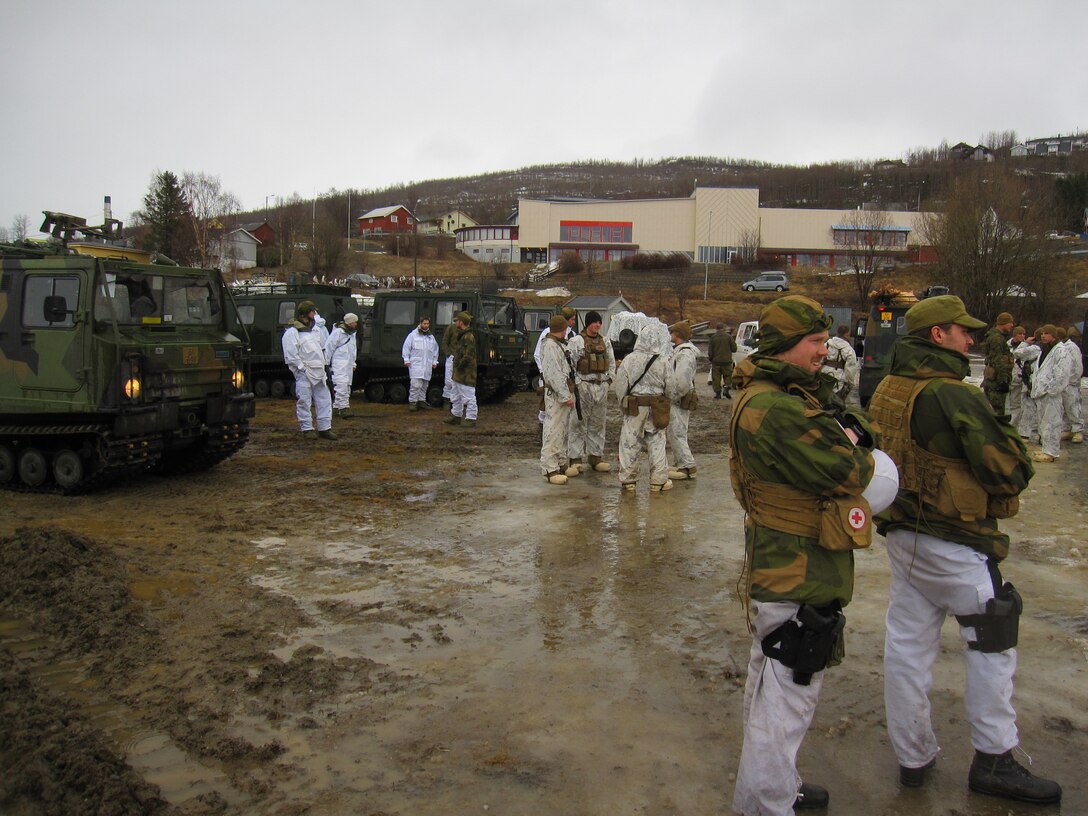 Marines with 2nd Battalion, 2nd Marine Regiment, 2nd Marine Division and soldiers with Bandvagn Company, Host Nation Suppot Battalion share a moment of rest during Cold Response 2014 at Bardufoss, Norway, March 13, 2014. BV Co. integrated Marines from 2nd Supply Battalion, Combat Logistics Regiment 25, 2nd Marine Logistics Group to increase the effectiveness of the company while operating with multinational forces. Cold Response 14 is a Norwegian-led multinational exercise above the Arctic Circle designed prepare for high-intensity cold-weather operations with nearly 16,000 troops from 16 different countries.