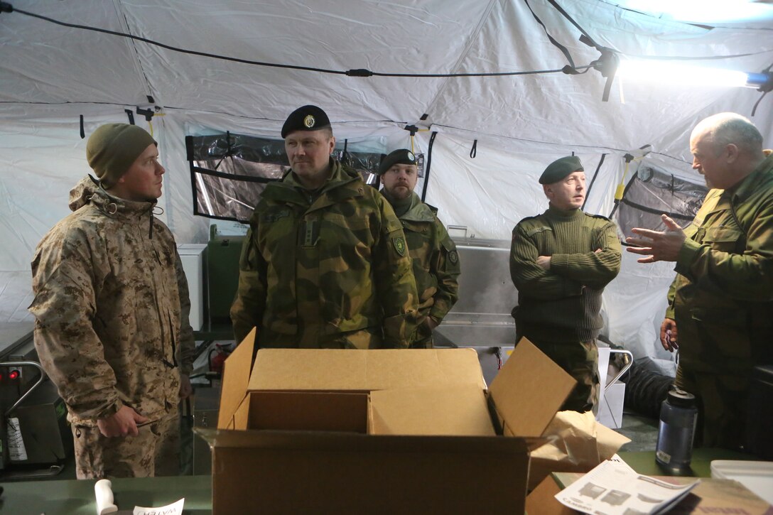 Sgt. Sean N. Davis (left), a food service specialist with 2nd Supply Battalion, Combat Logistics Regiment 25, 2nd Marine Logistics Group speaks with Col. Jorn E. Berntsen, the commanding officer of Operations Support Group Bardufoss during Cold Response 2014 at Elvegaardsmoen, Norway, March 15, 2014. Berntsen toured Elvegaardsmoen to visit the Norwegian and Marine forces during their integrated training. Cold Response 14 is a Norwegian-led multinational exercise above the Arctic Circle designed prepare for high-intensity cold-weather operations with nearly 16,000 troops from 16 different countries. 