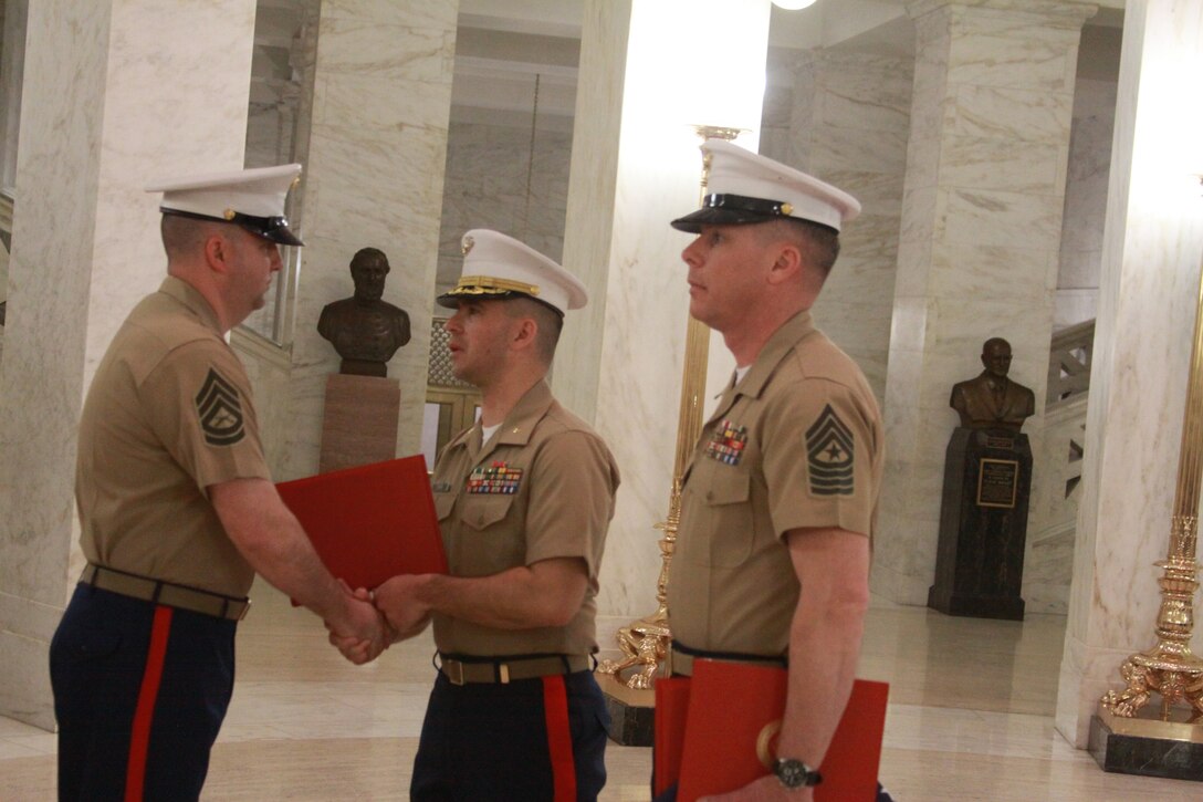 U.S. Marine Corps Gunnery Sgt. Darren McKeone, a Recruiting Station Charleston recruiter instructor and Fairmont, W. Va. native, receives certificates of appreciation from President Barack Obama, former President George H. W. Bush, the Commandant of the Marine Corps and the Sergeant Major of the Marine Corps, presented by U.S. Marine Corps Maj. Gabriel Diana, the commanding officer of RS Charleston, and U.S. Marine Corps Sgt. Maj. Dennis Bradley, the sergeant major of RS Charleston, during his retirement ceremony in Charleston, W.Va., March 21, 2014. McKeone served with RS Charleston from 2008 and retired after 20 years of service to his country. (U.S. Marine Corps photo by Sgt. Tyler Hlavac/Released)