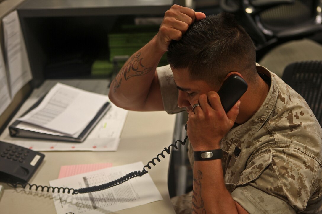 Sergeant Eric Castro, ammunition chief, Combat Logistics Regiment 1, 1st Marine Logistics Group, makes another phone call as he tries to coordinate a six-mile hike aboard Camp Pendleton, Calif., March 25, 2014. Castro was the acting logistics officer for the hike. During this training, noncommissioned officers acted roles of their superiors as they planned and led the hike. The goal of the hike was to empower NCOs and let them see the big picture. 