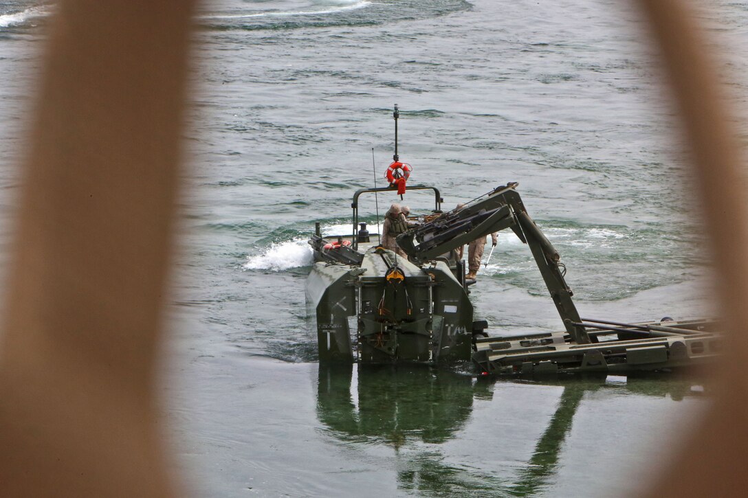 Marines with Bridge Company, 7th Engineer Support Battalion, 1st Marine Logistics Group, secure an Improved Ribbon Bridge, to extract it from the Colorado River, during a training exercise in Laughlin, Nev., March 17-21, 2014. More than 60 Marines trained in moving heavy equipment, to include 7-tons and Humvees, across a flowing body of water using BEBs and an Improved Ribbon Bridge. The IRB is a multi-piece floating bridge that can function as a raft. The BEBs were used to push the raft against the current. Despite being accustomed to training in a bay with little to no current, these Marines managed to transport two 7-tons up the river at the same time.