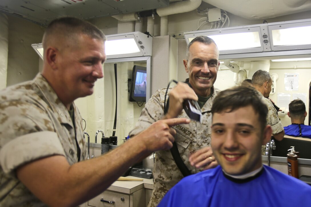 Brigadier Gen. Vincent A. Coglianese, commanding general, 1st Marine Logistics Group, and Col. Tracy W. King, commanding officer, Combat Logistics Regiment 15, 1st MLG, joke with a sailor aboard the LPD 23 amphibious transport dock ship, USS Anchorage, March 20, 2014. The USS Anchorage, with embarked Marines from 1st Marine Expeditionary Force, was off the coast of California conducting amphibious warfare certification training. The embarked Marines will conduct aircraft landing operations, live-fire training, martial arts and other drills in order to maintain their position as an expeditionary force in readiness.