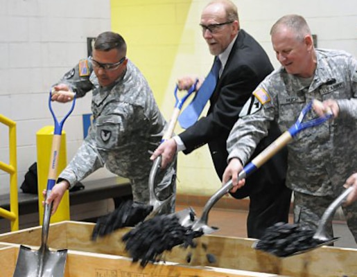 Col. David J. Luders, left, commander Rock Island Arsenal Joint Manufacturing and Technology Center; Congressman Dave Loebsack, who represents Iowa’s second congressional district and Col. Robert Ruch, commander, Huntsville Center, remove excess coal from the factory’s supply to symbolize energy savings to be realized in the Rock Island Arsenal JMTC Plating shop as a result of the changes made during the Energy Savings Performance Contract during a ceremony at Rock Island Arsenal.