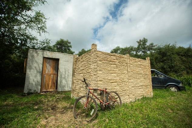 A job site displays the final product completed by Combat Logistics Battalion 3 Marines for a project at Marine Corps Training Area Bellows, March 21, 2014. The project’s purpose is to modify shipping container units into a low-quality home with a full roof, door and windows, to give the simulated appearance of a real home within the training area. The units placed in remote areas between military operations on urban terrain facilities would provide Marines a better training experience when patrolling through the different sites. (U.S. Marine Corps photo by Lance Cpl. Matthew Bragg)