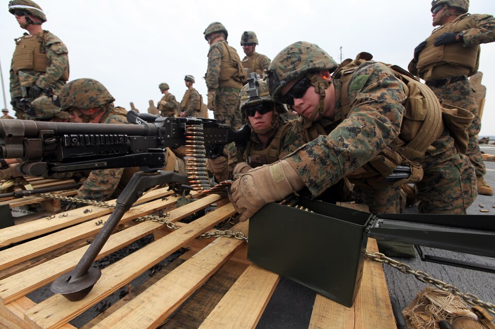 Lance Cpl. Zachary T. Love (right), a machine gunner with Company F., Battalion Landing Team 2nd Battalion, 5th Marine Regiment, 31st Marine Expeditionary Unit, and a native of Leewood, Kans., checks the belt of ammunition after reloading a M240B machine gun for teammate Lance Cpl. Bret N. Robison, a machine gunner with Co. F., BLT 2/5, 31st MEU, and native of San Diego, Calif., during live-fire sustainment training in the Combat Marksmanship Program here, March 19. The full-day event was composed of engaging targets at varying ranges using the M4 carbine, M16A4 service rifle, M9 pistol and M240B machine gun. The 31st MEU is currently completing its certification exercise, evaluated by Special Operations Training Group, III Marine Expeditionary Force, to assess the unit’s ability to accomplish mission essential tasks while deployed aboard the ships of the Bonhomme Richard Amphibious Ready Group. The 31st MEU is the Marine Corps’ force of choice for the Asia-Pacific region and the only continuously forward-deployed MEU.  