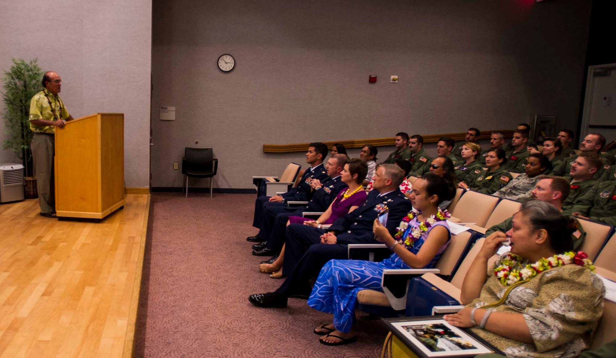 Tony Hollister, father to fallen loadmaster Staff Sgt. Robert “Danny” Hollister, speaks to a crowd of more than 75 attendees at a rededication ceremony on Joint Base Pearl Harbor-Hickam, Hawaii, March 28, 2014. During the ceremony, the 535th Airlift Squadron Auditorium was renamed the Hollister Auditorium, in memory of his late son. (U.S. Air Force photo/Tech. Sgt. Terri Paden)