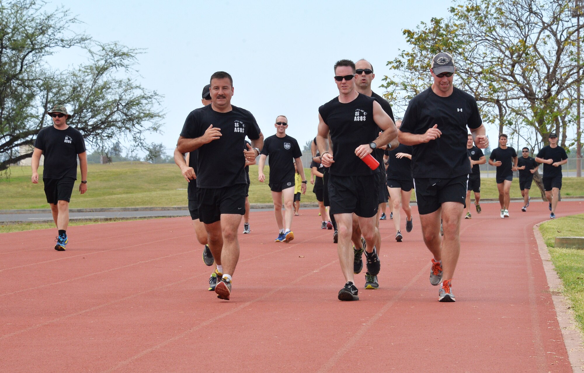 Members of the 25th Air Support Operations Squadron run the final few laps during a 24-hour run challenge at Joint Base Pearl Harbor-Hickam, Hawaii, March 28, 2014. The annual challenge honors fallen TACP members, as well as raises money for the U.S. Air Force TACP Association. More than 3,100 miles were logged by 25th ASOS and base members between 12 p.m. March 27 through 11:59 a.m. March 28. (U.S. Air Force photo/Staff Sgt. Alexander Martinez)