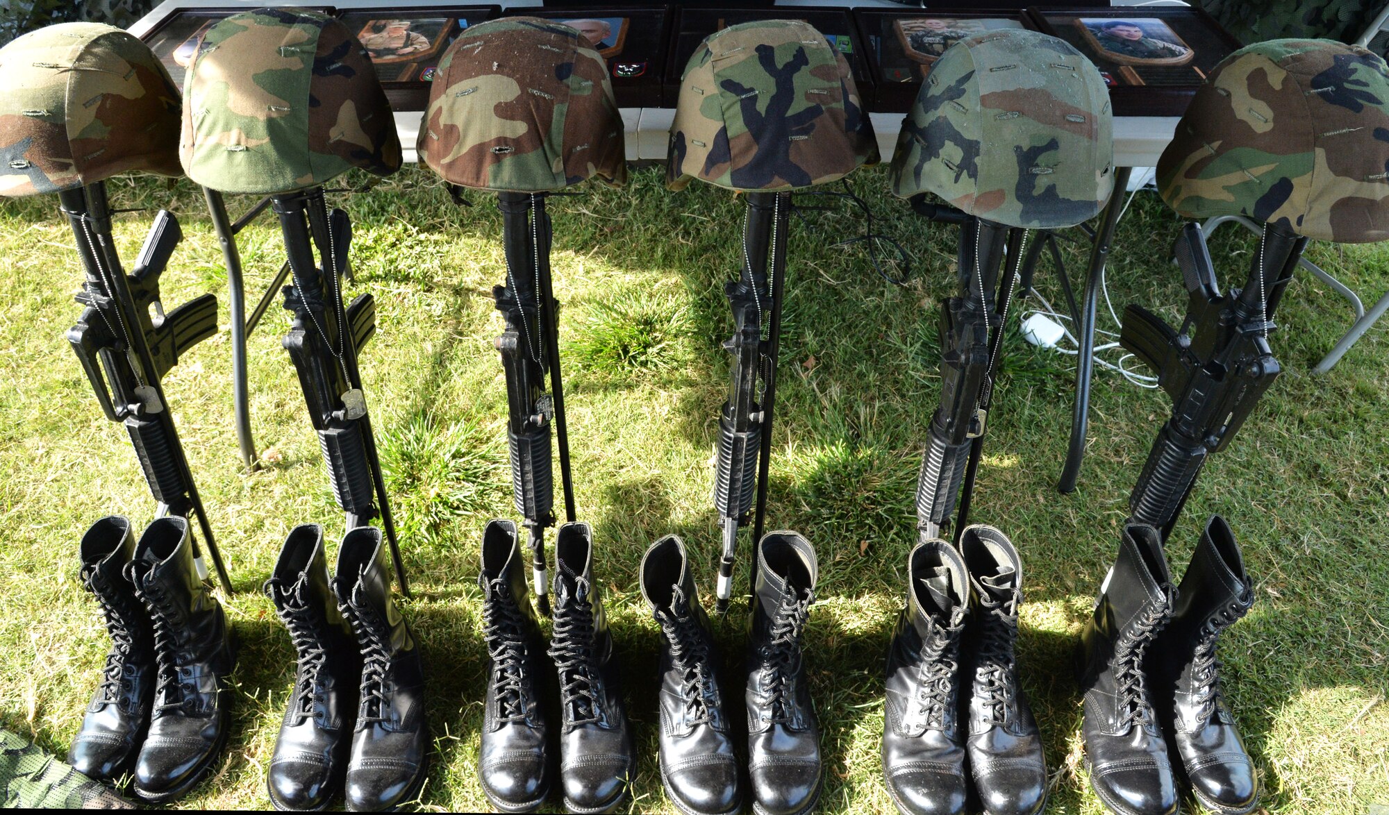 Six battlefield cross memorials, one for each tactical air combat party (TACP) killed in action, are displayed in front of their photos during the 25th Air Support Operations Squadron during a 24-hour run challenge at Joint Base Pearl Harbor-Hickam, Hawaii, March 28, 2014. The annual challenge honors fallen TACP members, as well as raises money for the U.S. Air Force TACP Association. More than 3,100 miles were logged by 25th ASOS and base members between 12 p.m. March 27 through 11:59 a.m. March 28. (U.S. Air Force photo/Staff Sgt. Alexander Martinez)