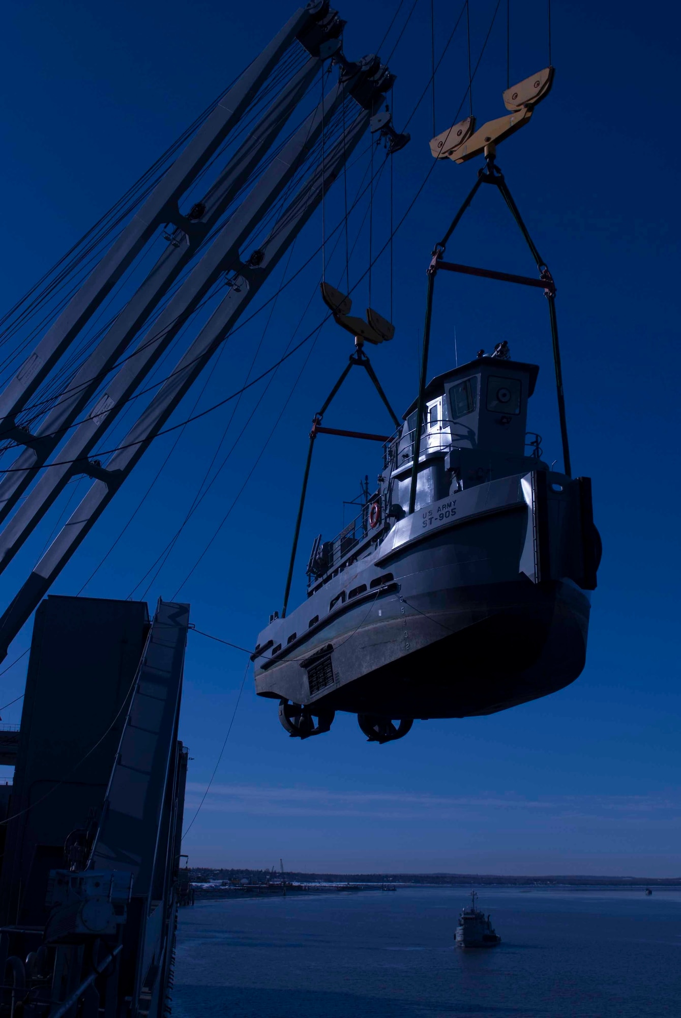 The Scholarie ST-905 is offloaded into the Knik Arm from the USNS Mendonca, a large cargo ship, into the during Alaska Shield 2014 in Anchorage, Alaska, March 27, 2014. The U.S. Army has several small tugs that can transport supplies to shore when port facilities are inoperative, degraded, or otherwise unavailable.. Alaska Shield is a U.S. government, State of Alaska, and local disaster exercise. (U.S. Army photo by Spc. Ryan A. Swanson)