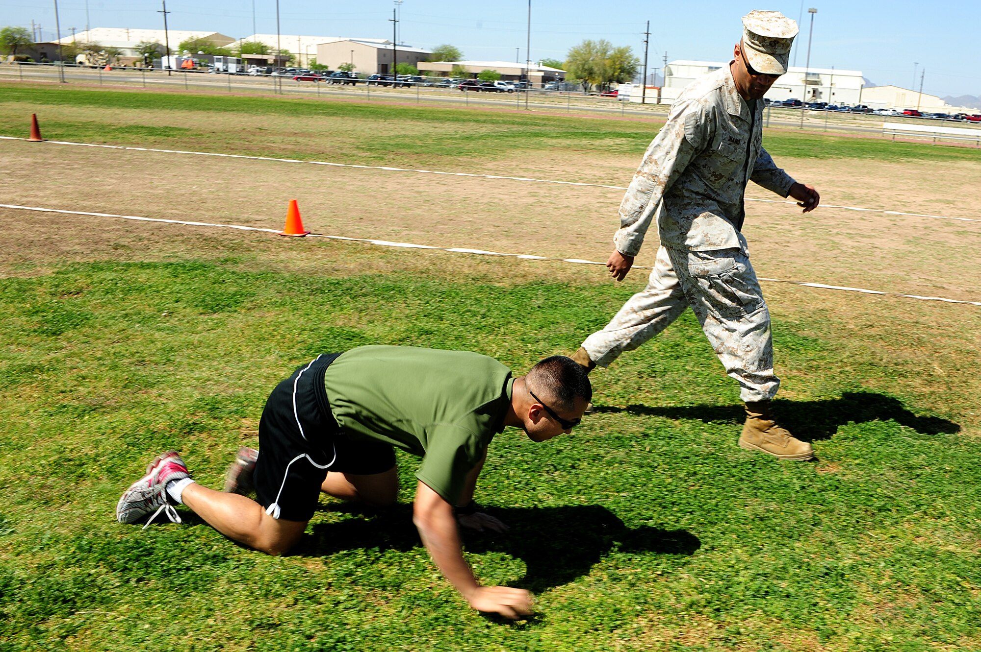 U.S. Marine SGT. Oliver Hand, Inspector Instructor Staff diary clerk, instructs Army SGT. Lixing Zhang, 285th Assault Aviation Battalion UH-60 Crew Chief through the ‘Maneuver Under Fire’ Marine Challenge at Davis-Monthan air Force Base, Ariz., March 28, 2014. The ‘Maneuver Under Fire’ Drill is the most complex part of the Marine Combat Fitness Test and is designed to measure functional fitness in a combat environment. (Air Force photo by Senior Airman Camilla Elizeu/Released)