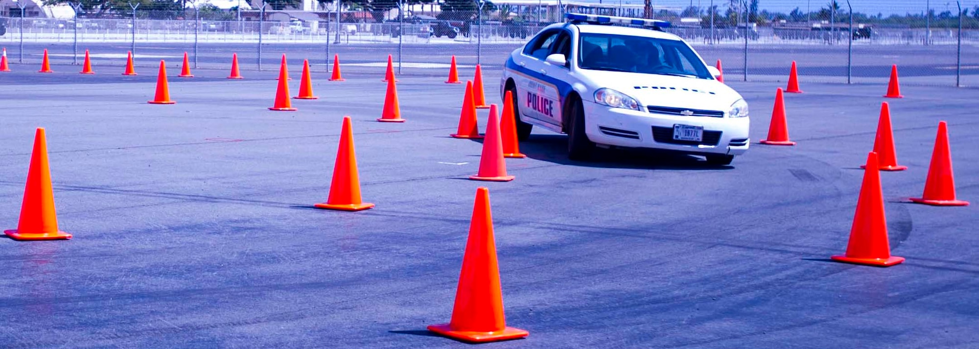 Police Capt. Jun Park, Emergency Vehicle Operator’s Course instructor, demonstrates the proper way to perform a radius turn in an emergency situation during the training course on Joint Base Pearl Harbor-Hickam, Hawaii, March 26, 2014. The EVOC prepares Airmen and Sailors to operate police, fire and emergency medical service vehicles in emergency situations. (U.S. Air Force photo/Tech. Sgt. Terri Paden)