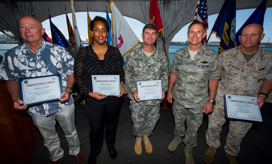 Maj. Gen. Kevin Pottinger, Mobilization Assistant to the Commander, Pacific Air Forces (second from right), recognizes platinum award winners for the 2013 Hawaii-Pacific Combined Federal Campaign recognition ceremony March 25, 2014, aboard the U.S.S. Missouri. The CFC presented platinum awards to federal organizations for garnering at least 60 percent participation and $95 per person in donations. (U.S. Air Force photo by Staff Sgt. Nathan Allen)