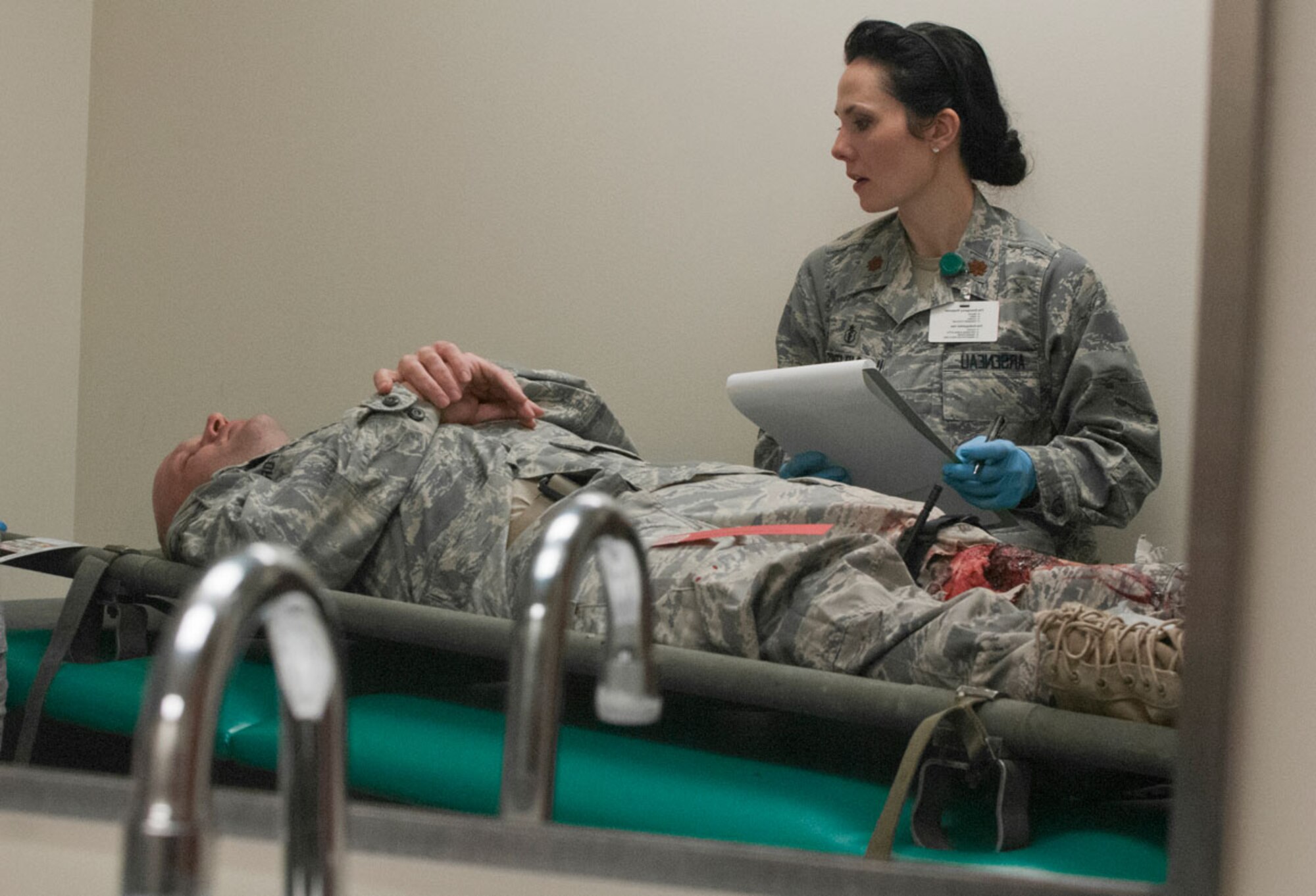 JOINT BASE ELMENDORF–RICHARDSON, Alaska--Air Force Maj. (Dr.) April Arseneau, 673d Medical Group, performs emergency patient care for a simulated earthquake casualty on Joint Base Elmendorf-Richardson, Alaska, March 27, 2014, during JBER's Mission Assurance Exercise 14-3. MAE 14-3 is a JBER exercise testing the base’s ability to survive, operate and coordinate during a major natural disaster. (U.S. Air Force photo/ Justin Connaher)