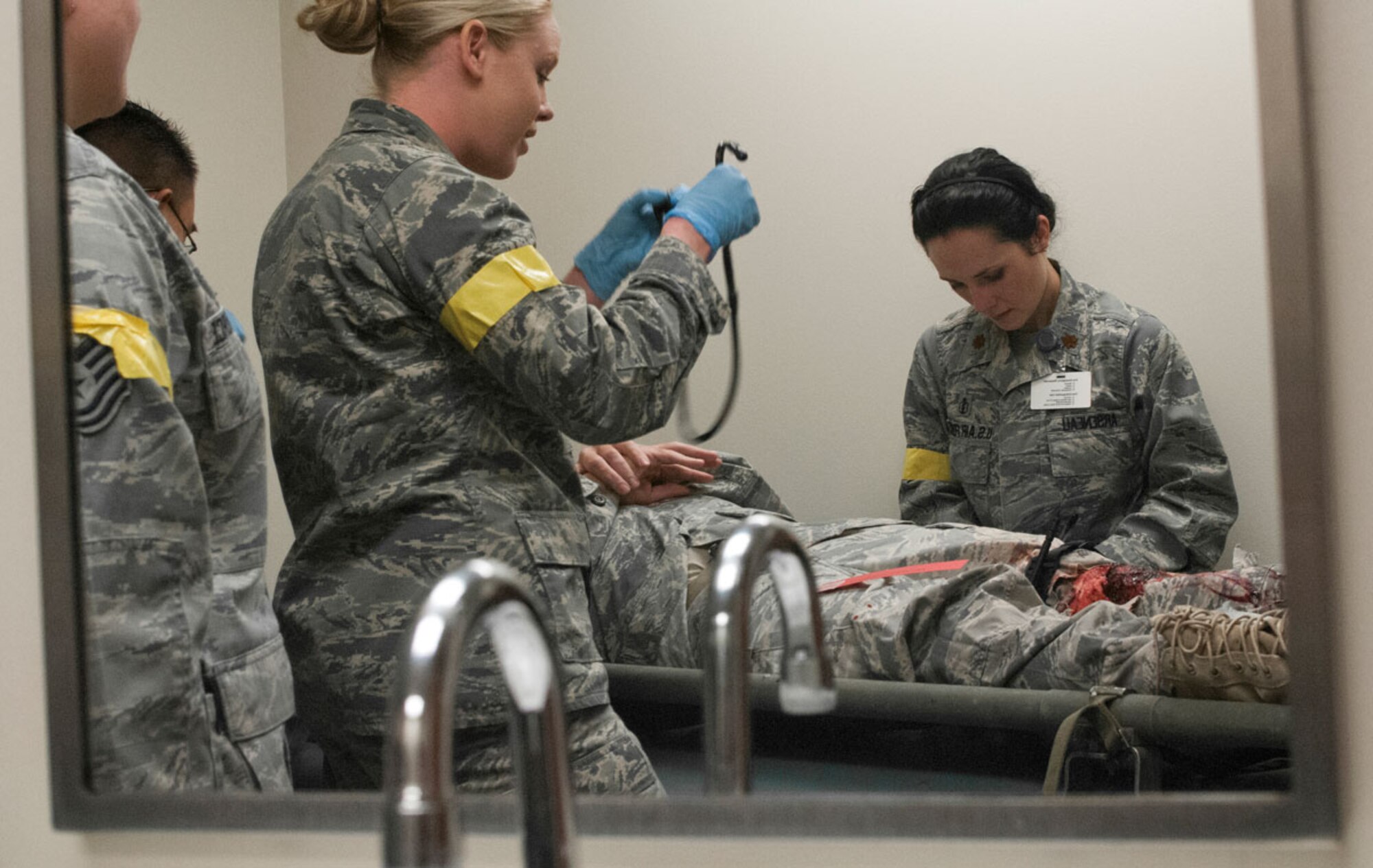 JOINT BASE ELMENDORF–RICHARDSON, Alaska--Air Force Maj. (Dr.) April Arseneau, 673d Medical Group, performs emergency patient care for a simulated earthquake casualty on Joint Base Elmendorf-Richardson, Alaska, March 27, 2014, during JBER's Mission Assurance Exercise 14-3. MAE 14-3 is a JBER exercise testing the base’s ability to survive, operate and coordinate during a major natural disaster. (U.S. Air Force photo/ Justin Connaher)