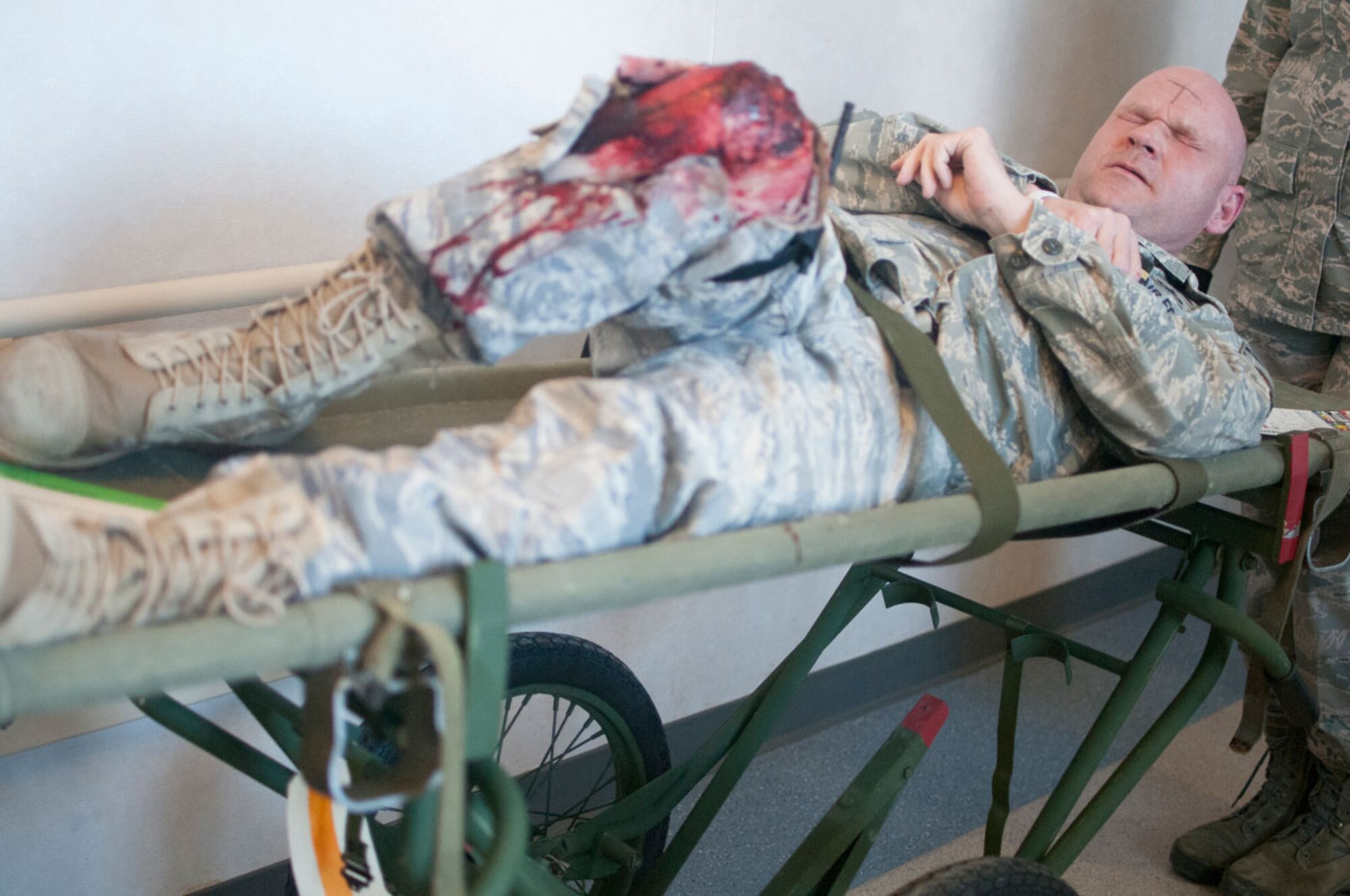 JOINT BASE ELMENDORF–RICHARDSON, Alaska--A simulated earthquake casualty winces in pain as he arrives at the base hospital at Joint Base Elmendorf-Richardson, Alaska, March 27, 2014, during JBER's Mission Assurance Exercise 14-3. MAE 14-3 is a JBER exercise testing the base’s ability to survive, operate and coordinate during a major natural disaster. (U.S. Air Force photo/Justin Connaher)