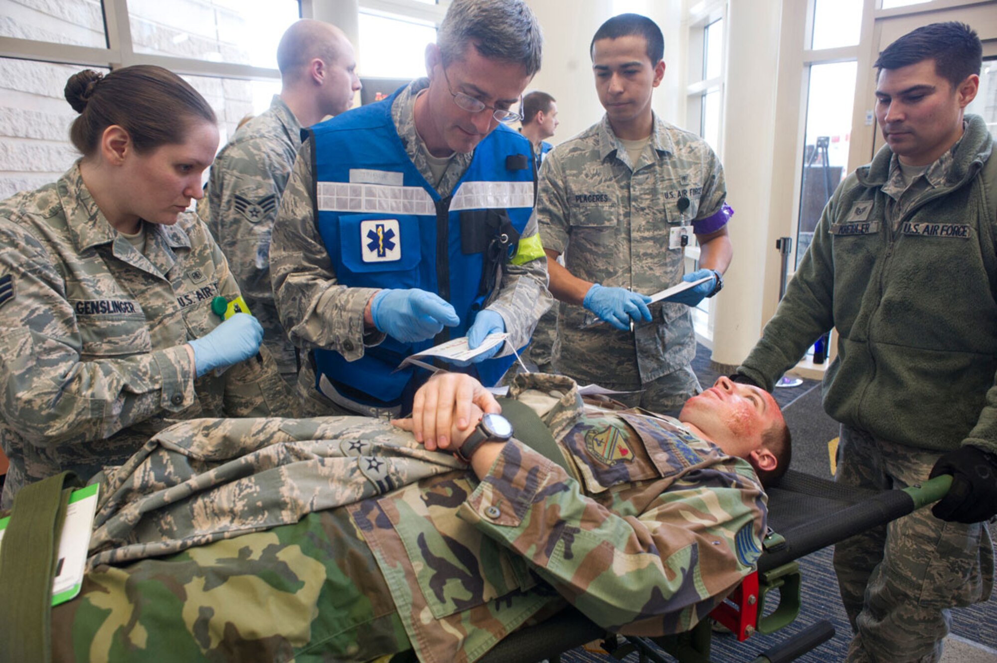 JOINT BASE ELMENDORF–RICHARDSON, Alaska--Air Force Lt. Col. (Dr.) Michael Michener, center, 673d Medical Group, evaluates a simulated earthquake casualty while performing triage at Joint Base Elmendorf-Richardson, Alaska, March 27, 2014, during JBER's Mission Assurance Exercise 14-3. MAE 14-3 is a JBER exercise testing the base’s ability to survive, operate and coordinate during a major natural disaster. (U.S. Air Force photo/Justin Connaher)