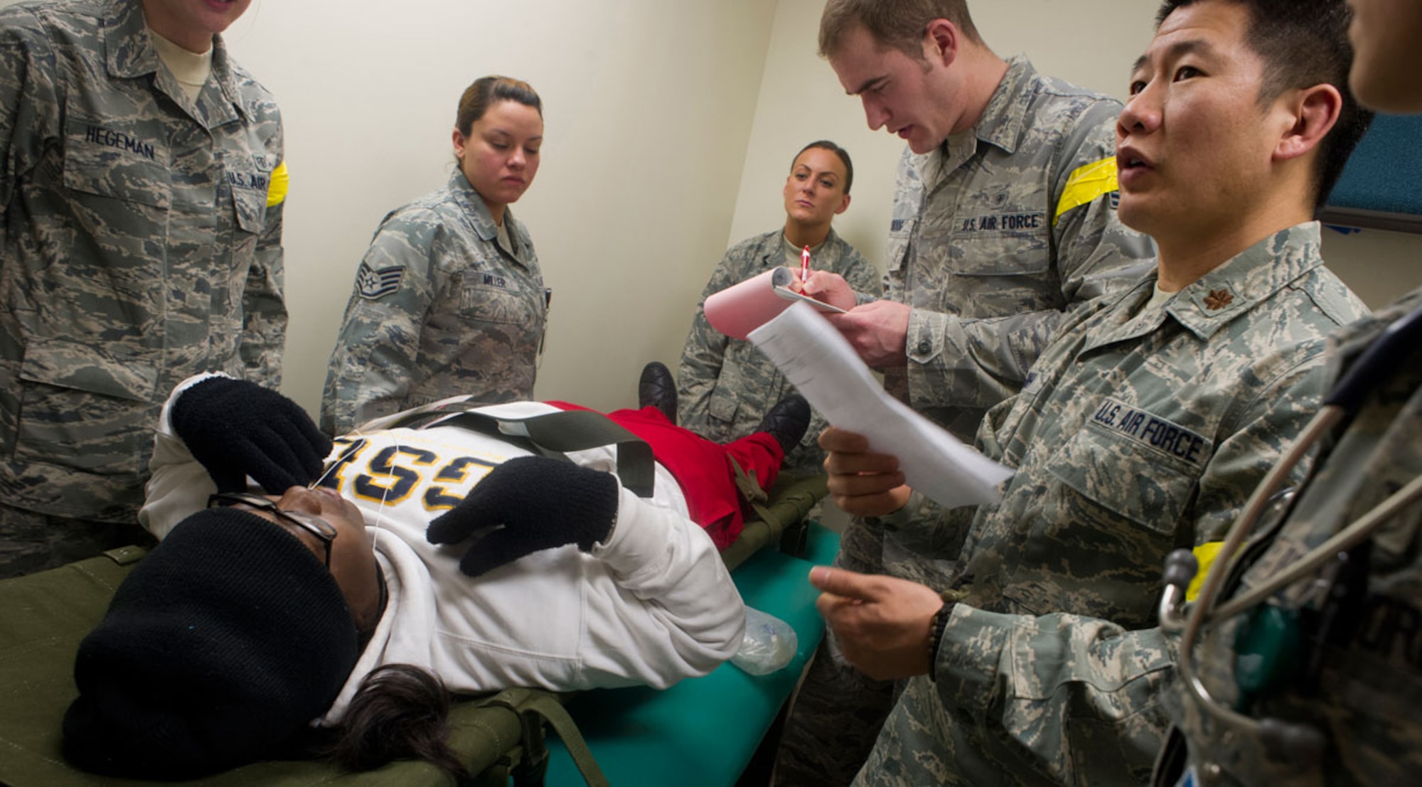 Air Force Maj. (Dr.) Roger Shih, right, 673d Medical Group, discusses emergency patient care for a simulated earthquake casualty with his team at the base hospital at Joint Base Elmendorf-Richardson, Alaska, March 27, 2014, during JBER's Mission Assurance Exercise 14-3. MAE 14-3 is a JBER exercise testing the base’s ability to survive, operate and coordinate during a major natural disaster. (U.S. Air Force photo/Justin Connaher)