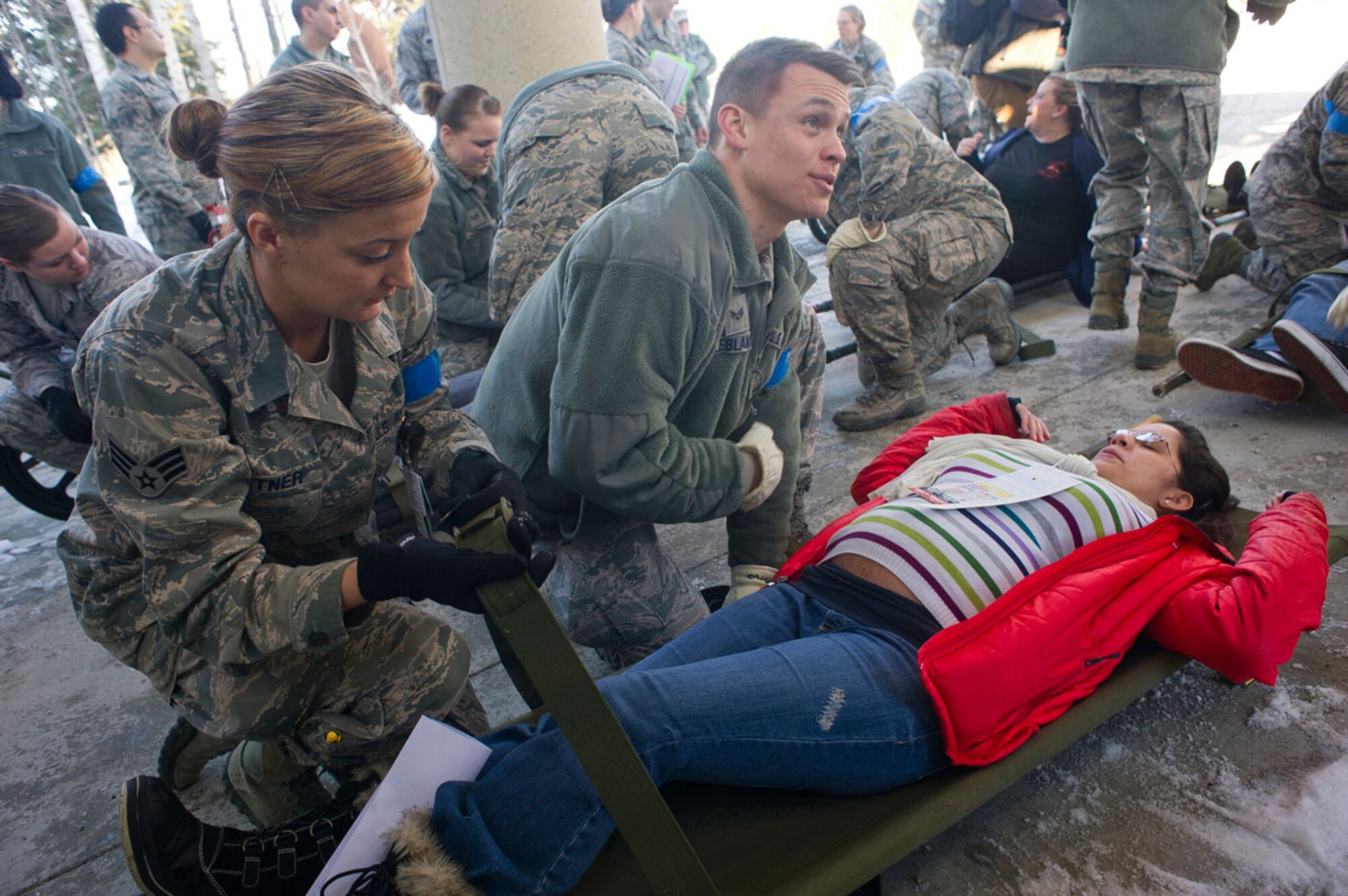 JOINT BASE ELMENDORF–RICHARDSON, Alaska--Air Force Senior Airman Brittany Pritner and Senior Airman Taylor LeBlanc, 673d Medical Group, perform triage for a pregnant simulated earthquake casualty at Joint Base Elmendorf-Richardson, Alaska, March 27, 2014, during JBER's Mission Assurance Exercise 14-3. MAE 14-3 is a JBER exercise testing the base’s ability to survive, operate and coordinate during a major natural disaster. (U.S. Air Force photo/Justin Connaher)