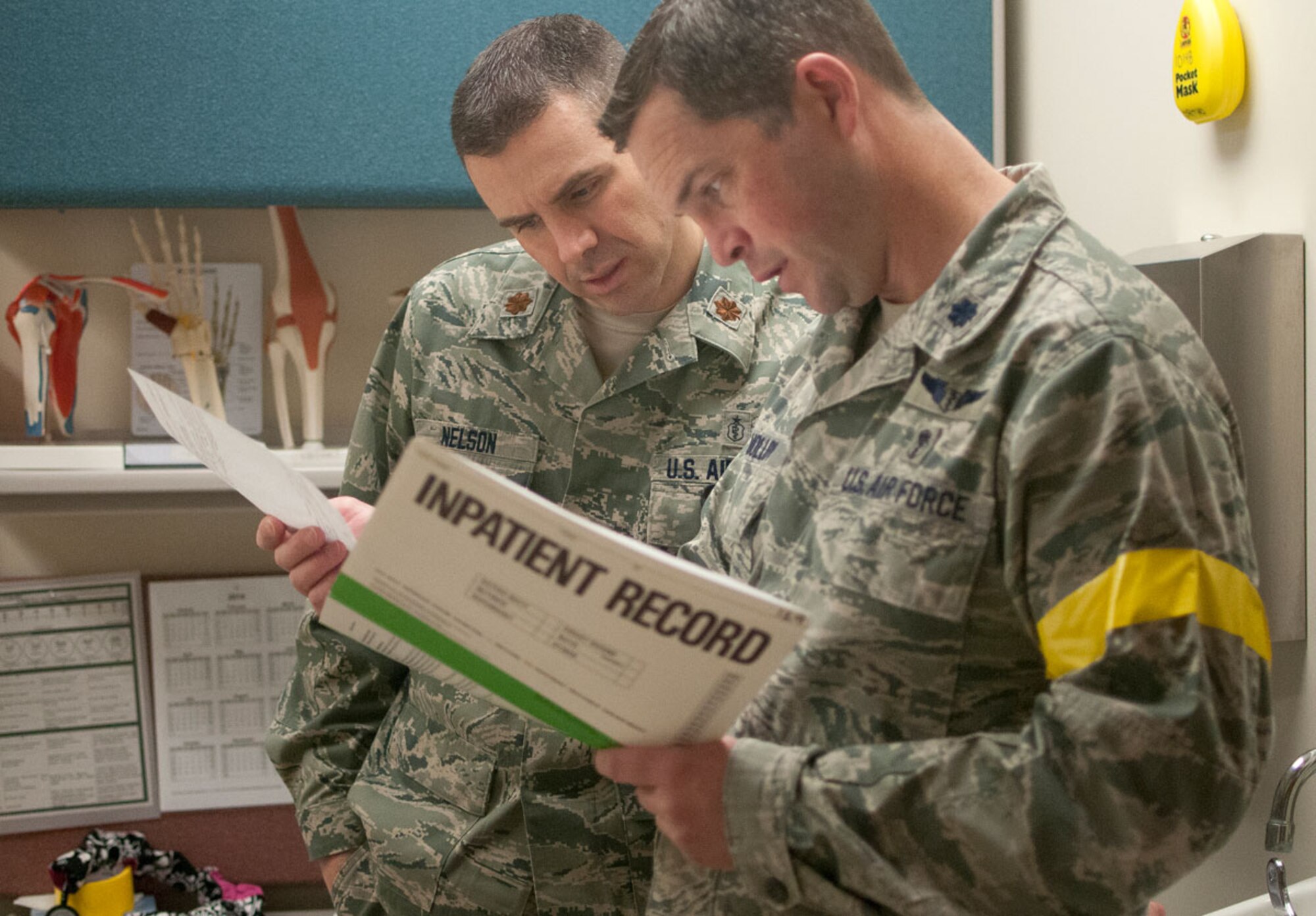JOINT BASE ELMENDORF–RICHARDSON, Alaska--Air Force Maj. (Dr.) Austin Nelson and Lt. Col. (Dr.) Jeffrey Molloy, 673d Medical Group, discuss patient care for a simulated earthquake casualty at Joint Base Elmendorf-Richardson, Alaska, March 27, 2014, during JBER's Mission Assurance Exercise 14-3. MAE 14-3 is a JBER exercise testing the base’s ability to survive, operate and coordinate during a major natural disaster. (U.S. Air Force photo/Justin Connaher)