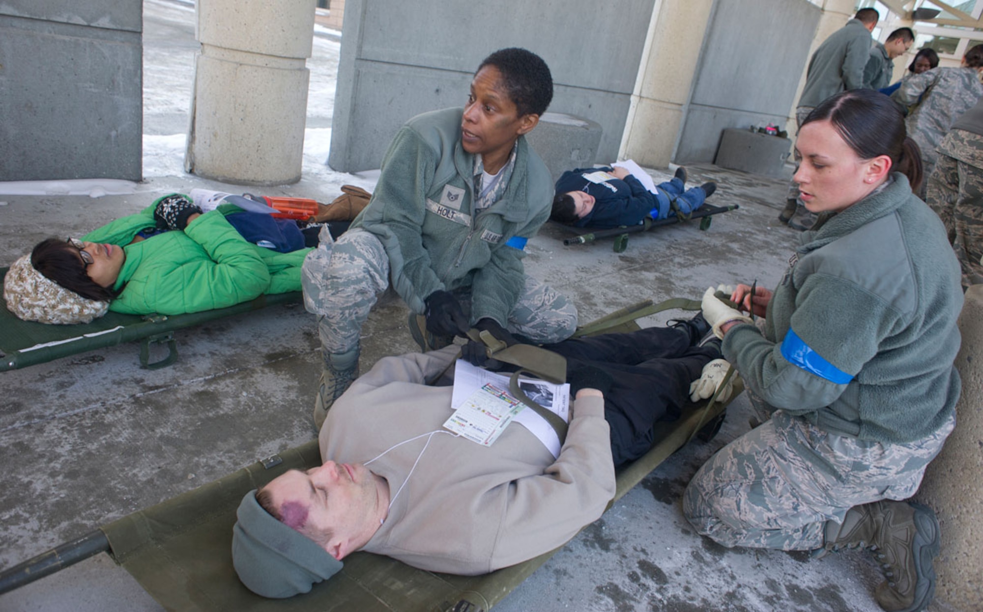 JOINT BASE ELMENDORF–RICHARDSON, Alaska--Air Force Staff Sgt. Stephanie Holt and Senior Airman Brittany Knight, 673d Medical Group, perform triage for a simulated earthquake casualty at Joint Base Elmendorf-Richardson, Alaska, March 27, 2014, during JBER's Mission Assurance Exercise 14-3. MAE 14-3 is a JBER exercise testing the base’s ability to survive, operate and coordinate during a major natural disaster. (U.S. Air Force photo/Justin Connaher)