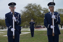 The Joint Base San Antonio-Randolph Honor Guard performs a tribute to former Vietnam War prisoners of war and those who remain missing in action during the 41st Freedom Flyer Reunion Wreath-laying Ceremony March 28 at Washington Circle. Annually, the Freedom Flyers return to JBSA-Randolph to share their stories and visit the site where they received their flying recertification, or their final flight, after their return from prisoner-of-war status. (U.S. Air Force photo by Joel Martinez)