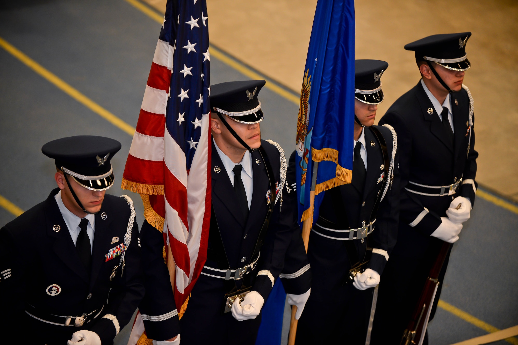 Ellsworth Honor Guard members stand ready to present the colors during the 2013 Maintenance Professional of the Year banquet in the Pride Hangar at Ellsworth Air Force Base, S.D., March 21, 2014. The MPOY banquet recognizes the achievements of the maintenance group and honors maintenance professionals each year. (U.S. Air Force photo by Senior Airman Zachary Hada/Released)