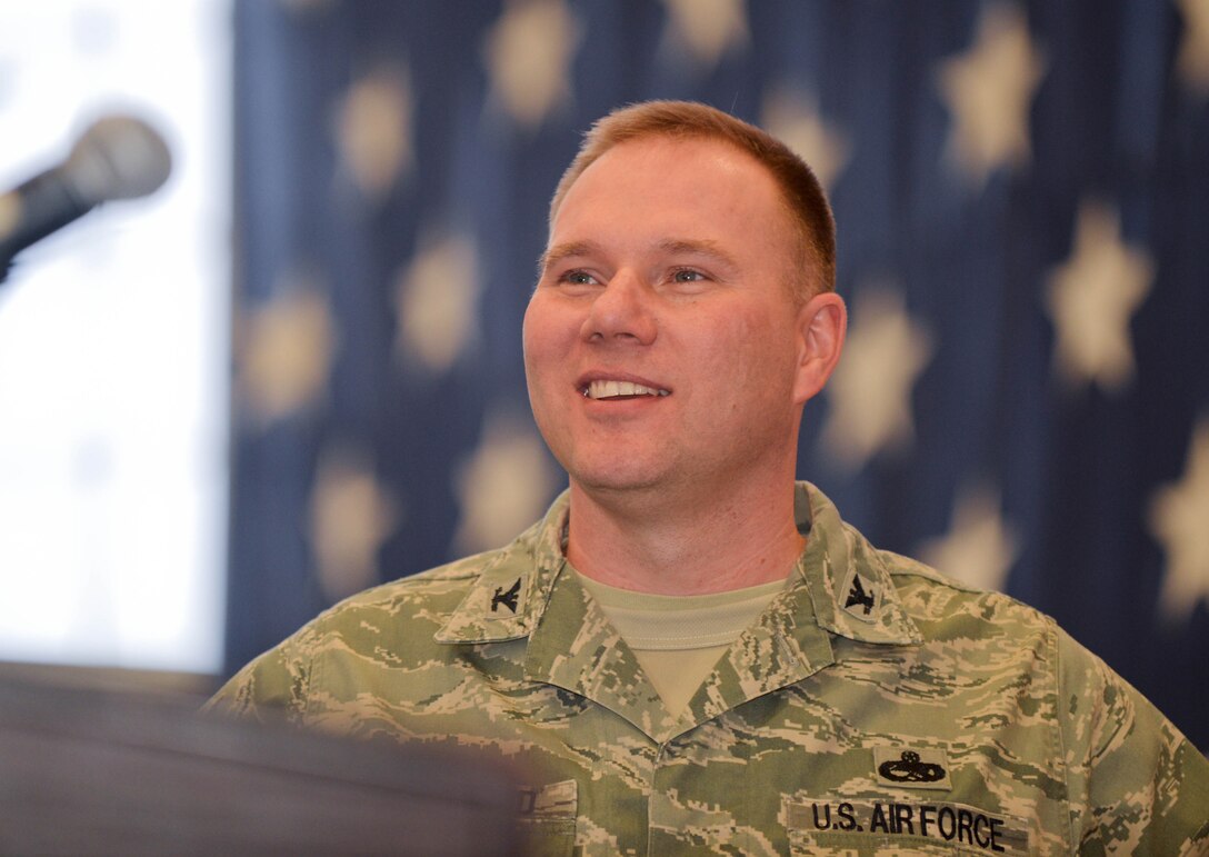 Col. Brooks McFarland, 28th Maintenance Group commander, speaks with Airmen during the 2013 Maintenance Professional of the Year banquet in the Pride Hangar at Ellsworth Air Force Base, S.D., March 21, 2014. Airmen, family members and base leaders gathered to recognize base maintenance professionals for their hard work and dedication. (U.S. Air Force photo by Senior Airman Zachary Hada/Released)