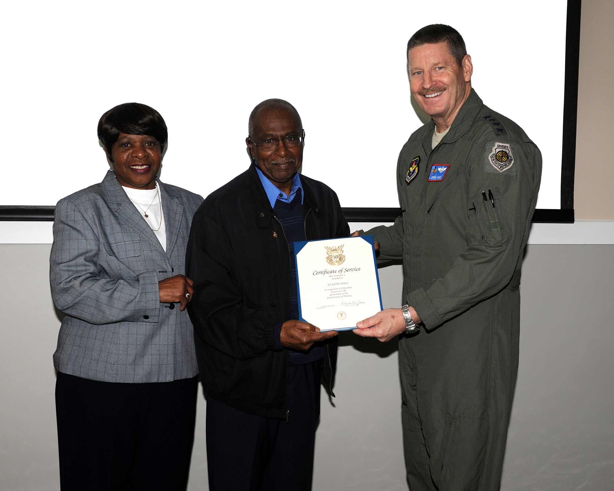 Gen. Robin Rand, commander of Air Education and Training Command, presents Eugene Hall, 14th Operations Group, with a 50 Year Certificate of Service recognizing his half-century of dedication to the U.S. Air Force during a ceremony at Columbus Air Force Base, Miss., March 26. Rand and AETC Command Chief Master Sgt. Gerardo Tapia visited Columbus AFB March 26 and 27 to meet with Airmen and evaluate the base operations. (U.S. Air Force Photo by Elizabeth Owens)