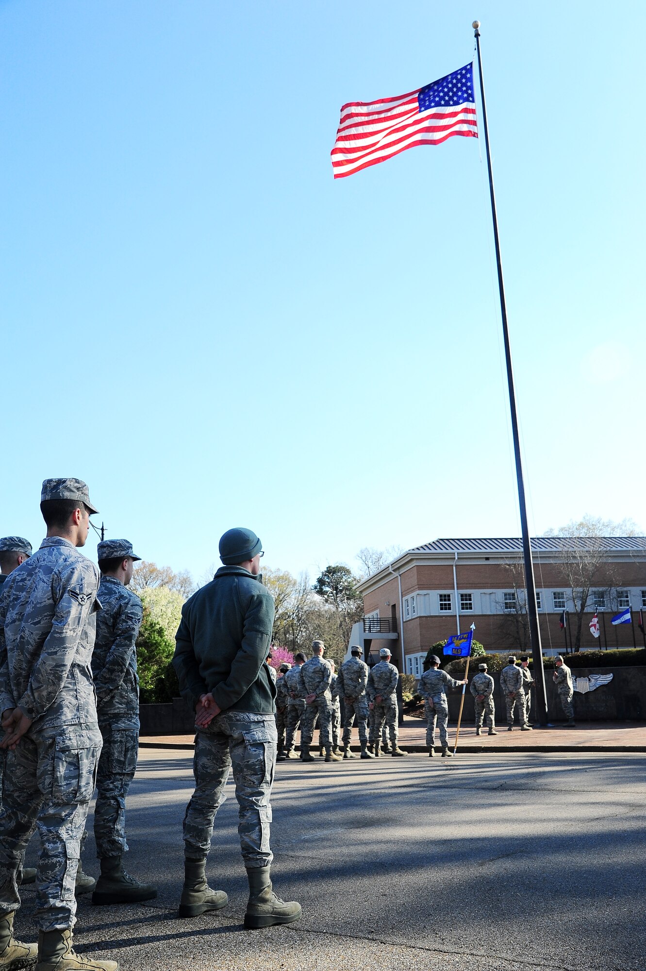 Airman Leadership School class 14-03 and personnel from base stand at parade rest during a retreat ceremony at Columbus Air Force Base, Miss., March 25, 2014. The retreat ceremony encompasses decades of Air Force history and American pride and performed at the end of the duty day. (U.S. Air Force photo/ Airman 1st Class Daniel Lile)