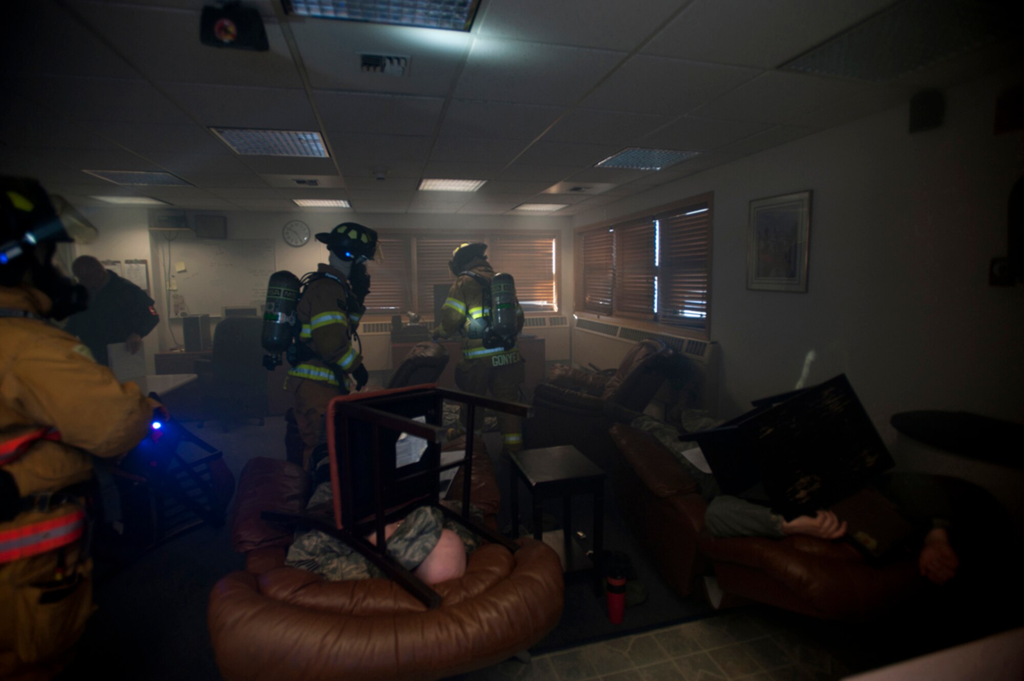 Firefighters from the 673d Civil Engineer Squadron search for victims after a simulated earthquake during Joint Base Elmendorf-Richardson's Mission Assurance Exercise 14-3, part of the overall Alaska Shield disaster response preparedness and response exercise March 27, 2014. The exercise aimed to test the base’s ability to survive and operate during a major natural disaster. (U.S. Air Force photo/Staff Sgt. Robert Barnett)