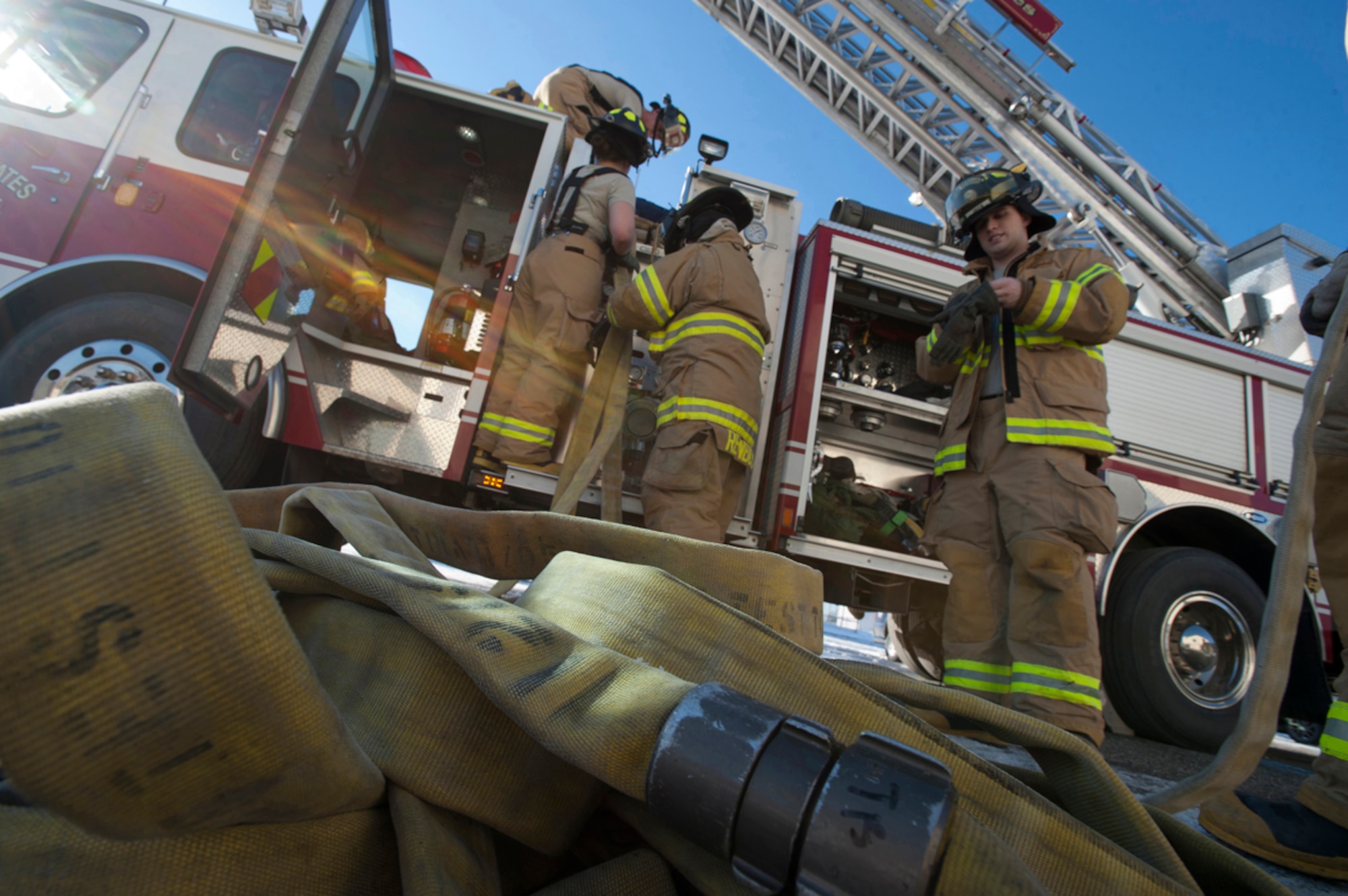 Firefighters from the 673d Civil Engineer Squadron pack up their fire hoses after a simulated earthquake emergency scenario during Joint Base Elmendorf-Richardson's Mission Assurance Exercise 14-3, part of the overall Alaska Shield disaster response preparedness and response exercise March 27, 2014. The exercise aims to test the base???s ability to survive and operate during a major natural disaster. (U.S. Air Force photo/Staff Sgt. Robert Barnett)
