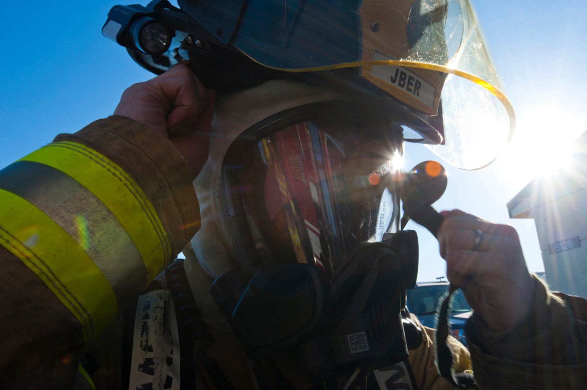 Airman 1st Class William White, 673d Civil Engineer Squadron firefighter, gears up in response to a simulated emergency call from inside Fire Station 2 after a simulated earthquake during Joint Base Elmendorf-Richardson's Mission Assurance Exercise 14-3, part of the overall Alaska Shield disaster response preparedness and response exercise March 27, 2014. JBER???s MAE 14-3 aims to test the base???s ability to operate during a major natural disaster. (U.S. Air Force photo/Staff Sgt. Robert Barnett)