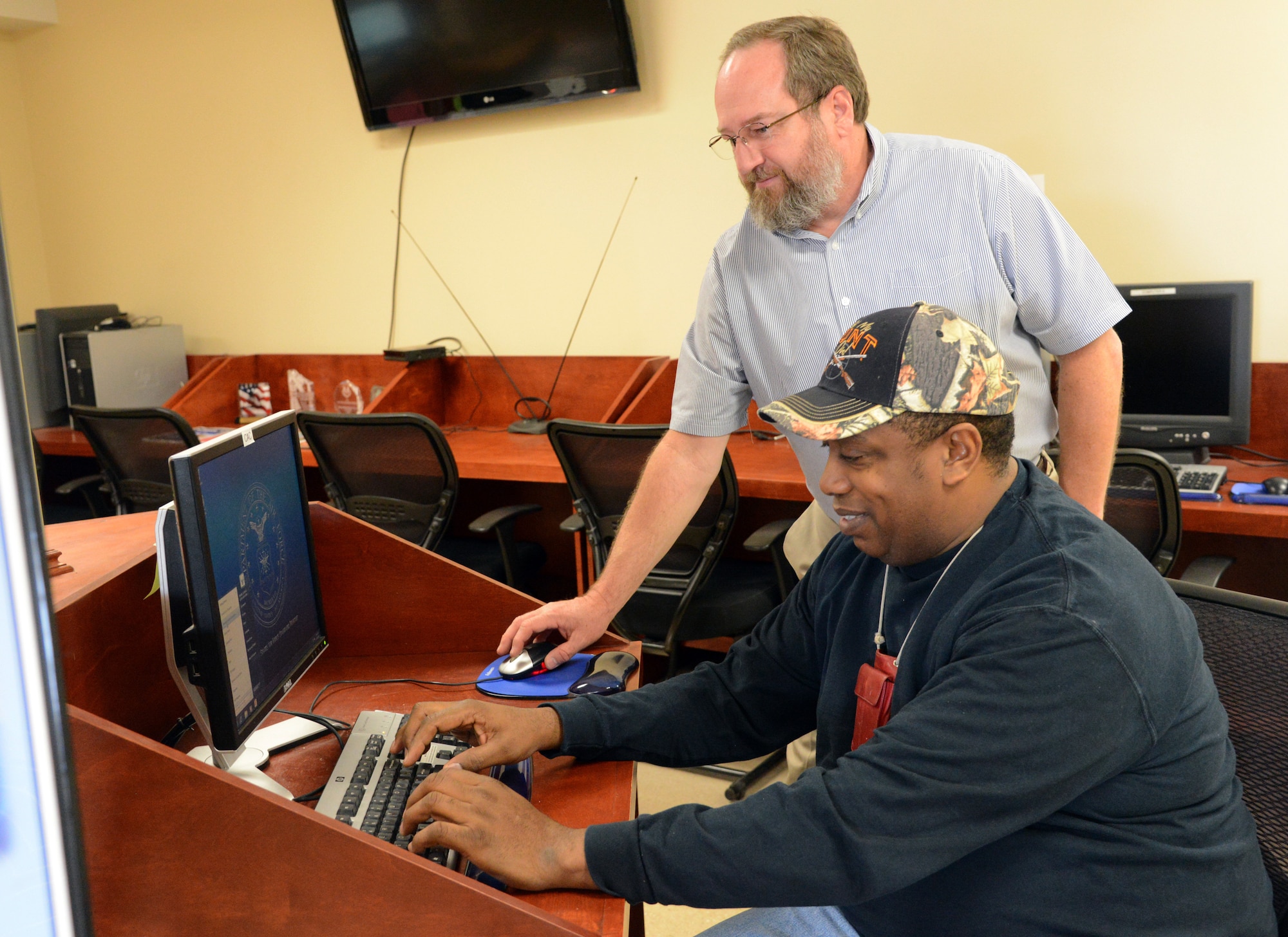 Glenn Grubis, a community readiness specialist, shows Marvin Broughton, of the 72nd Force Support Squadron, how to use the Resource Center at the Airman and Family Readiness Center. Computers are available for anyone, including non-CAC holders, to use to build their resumés, apply for Air Force Aid or to simply check their email. (Air Force photo by Kelly White)