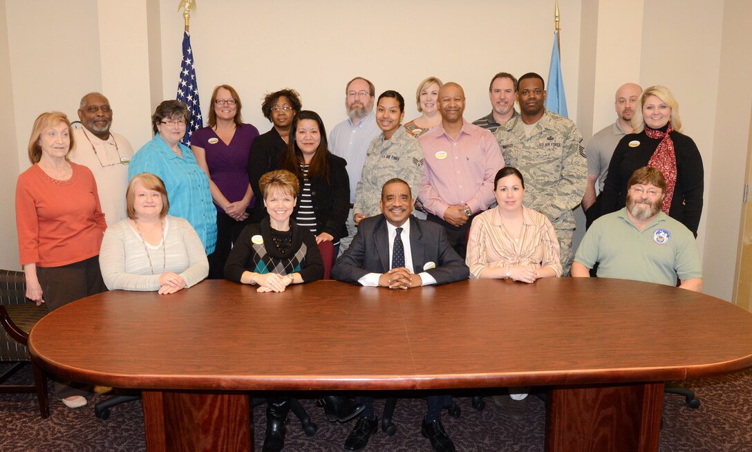 The team at the Tinker Airman and Family Readiness Center is dedicated to helping everyone — low income families in need of extra groceries, spouses needing help filling out resumés, Airmen retiring and transitioning into the civilian workforce. The A&FRC has been named the Best in Air Force for 2013. Pictured are, seated from left, Cathy Rosner, Tressie Taylor, Rickie Smith, Lena Jackson and Steve Auld; standing from left, Julia Gant, Raymond Brown, Carolyn Smith, Patti Black, Allison Blake, Suzi Pacheco, Glenn Grubis, Senior Airman Mercedes Sanchez, Heather Wojciuch, Dana Reynolds, Randy Wray, Master Sgt. Aubrey Quarles, Jerry Melton and Julie Franklin. (Air Force photo by Kelly White)