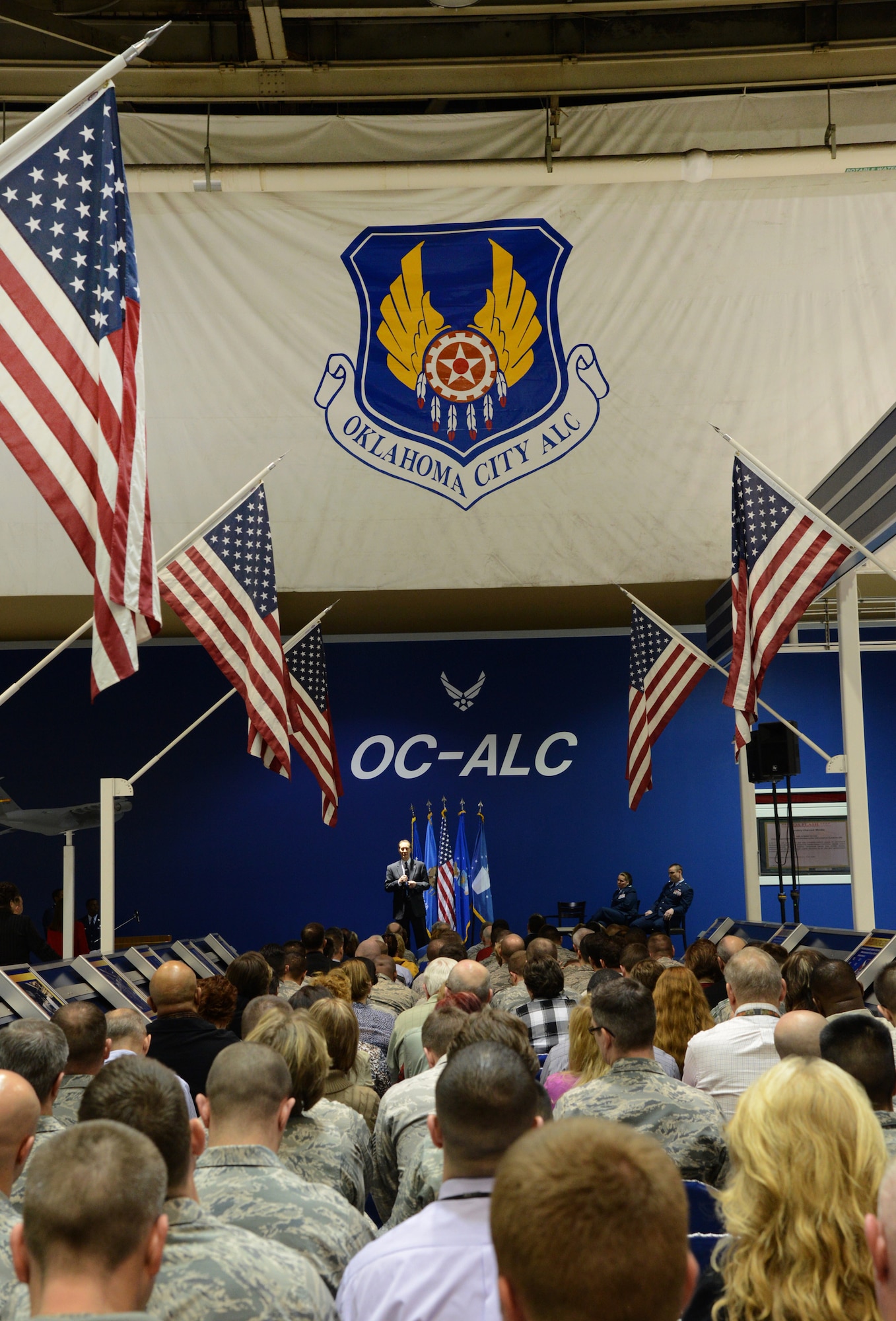 The main aisle of Bldg. 3001’s Hollywood and Vine was packed with guests who came to witness Capt. Alan Reynolds receiving the prestigious Purple Heart medal March 12. Ross Marshall, executive director of the Air Force Sustainment Center, presided over the ceremony and gave opening remarks. Col. Linda Hurry, Oklahoma City Air Logistics Complex deputy commander for Maintenance, pinned the Purple Heart on Captain Reynolds. (Air Force photo by Kelly White)