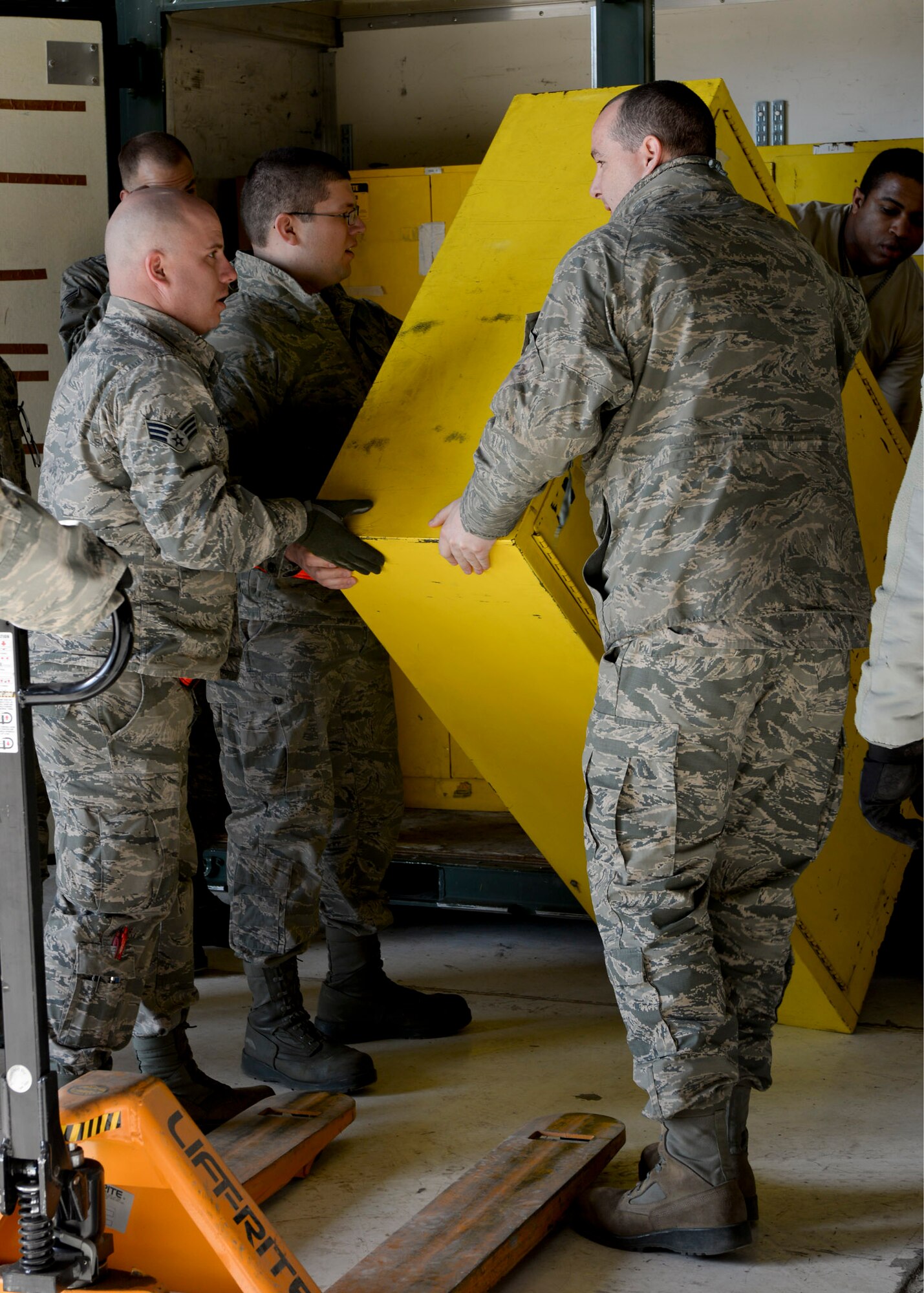 Airmen from the 5th Maintenance Squadron at Minot Air Force Base, N.D., unpack equipment inside a hangar at Ellsworth Air Force Base, S.D., May 25, 2014. More than 300 Airmen and approximately eight B-52 Stratofortresses will be temporarily operating out of Ellsworth during a runway repair project at their base. (U.S. Air Force photo by Senior Airman Anania Tekurio/Released)