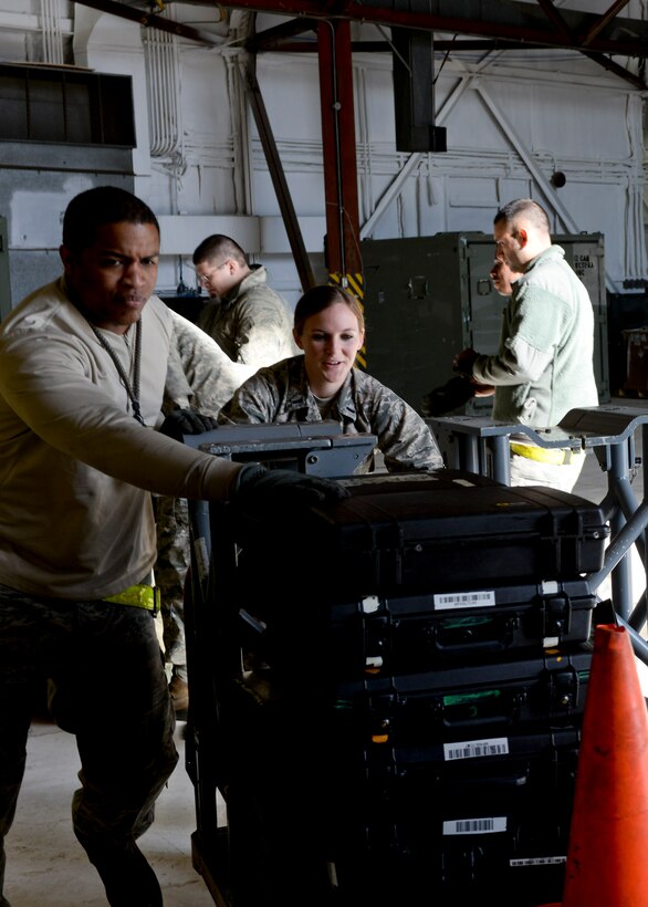 Airmen from the 5th Maintenance Squadron at Minot Air Force Base, N.D., unpack equipment inside a hangar at Ellsworth Air Force Base, S.D., May 25, 2014. Approximately 300 Airmen from Minot will be on temporary duty at Ellsworth due to a runway reconstruction project on their base. (U.S. Air Force photo by Senior Airman Anania Tekurio/ Released)