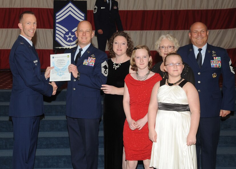 Chief Master Sgt. Timothy Gibson, 2nd Operations Support Squadron, receives a certificate of promotion from Col. Leland Bohannon, 2nd Bomb Wing vice commander, and Chief Master Sgt. Stephen Lebrun, 2nd Operations Group, during the January Wing Promotion Ceremony on Barksdale Air Force Base, La., Jan. 31, 2014. (U.S. Air Force photo)