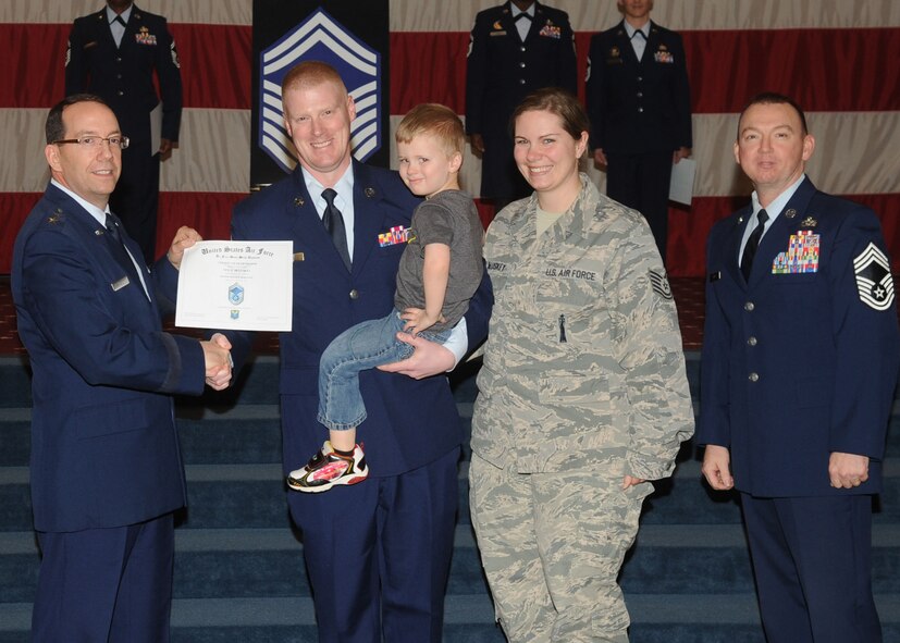 Senior Master Sgt. Neil McLuskey, Air Force Global Strike Command, receives a certificate of promotion from Maj. Gen. Robert Rego, AFGSC vice commander, during the January Wing Promotion Ceremony on Barksdale Air Force Base, La., Jan. 31, 2014. (U.S. Air Force photo)
