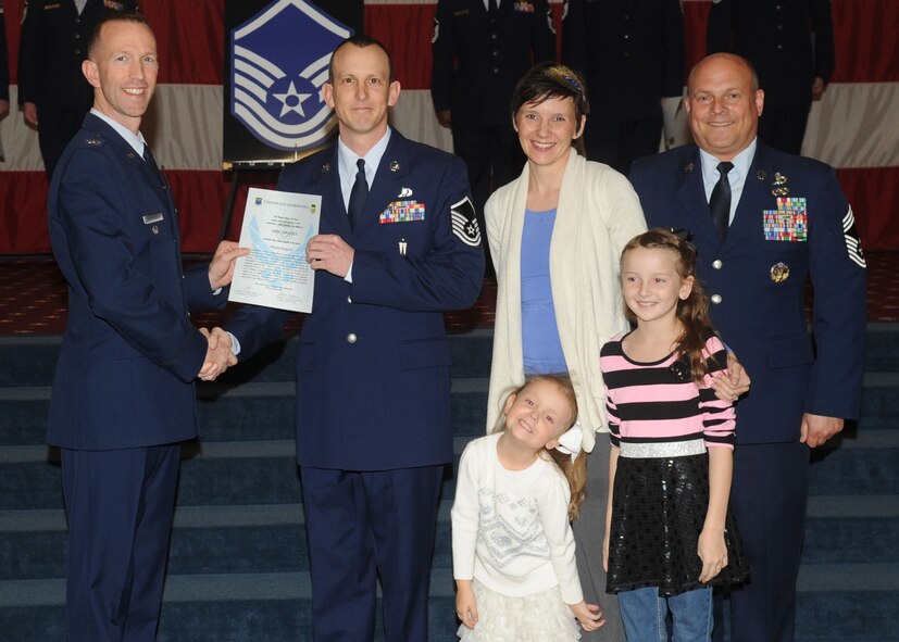 Master Sgt. Eric Sparks, 2nd Munitions Squadron, receives a certificate of promotion from Col. Leland Bohannon, 2nd Bomb Wing vice commander, and Chief Master Sgt. Stephen Lebrun, 2nd Operations Group, during the January Wing Promotion Ceremony on Barksdale Air Force Base, La., Jan. 31, 2014. (U.S. Air Force photo)