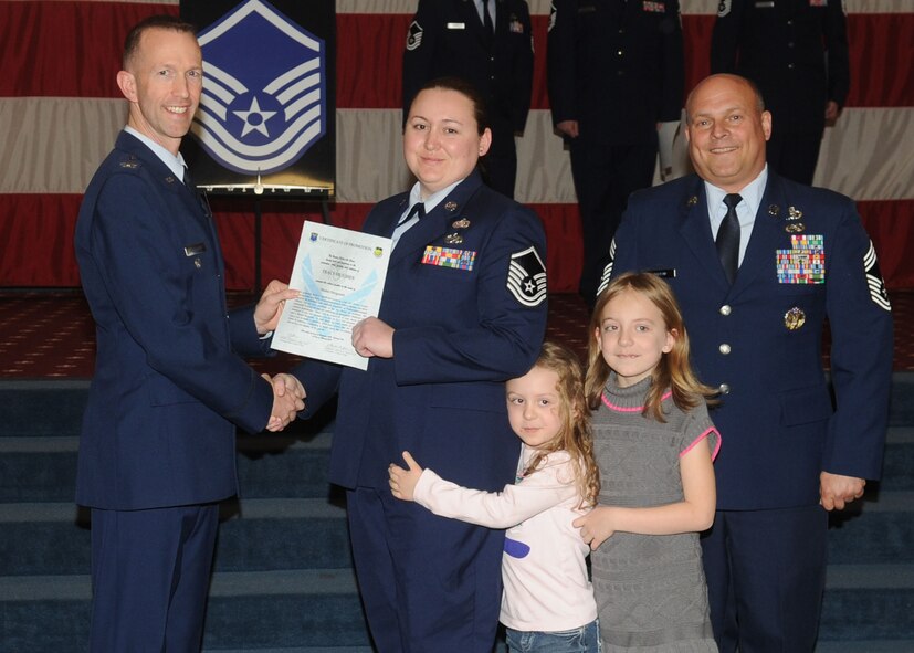 Master Sgt. Tracy Hughes, 2nd Civil Engineer Squadron, receives a certificate of promotion from Col. Leland Bohannon, 2nd Bomb Wing vice commander, and Chief Master Sgt. Stephen Lebrun, 2nd Operations Group, during the January Wing Promotion Ceremony on Barksdale Air Force Base, La., Jan. 31, 2014. (U.S. Air Force photo)